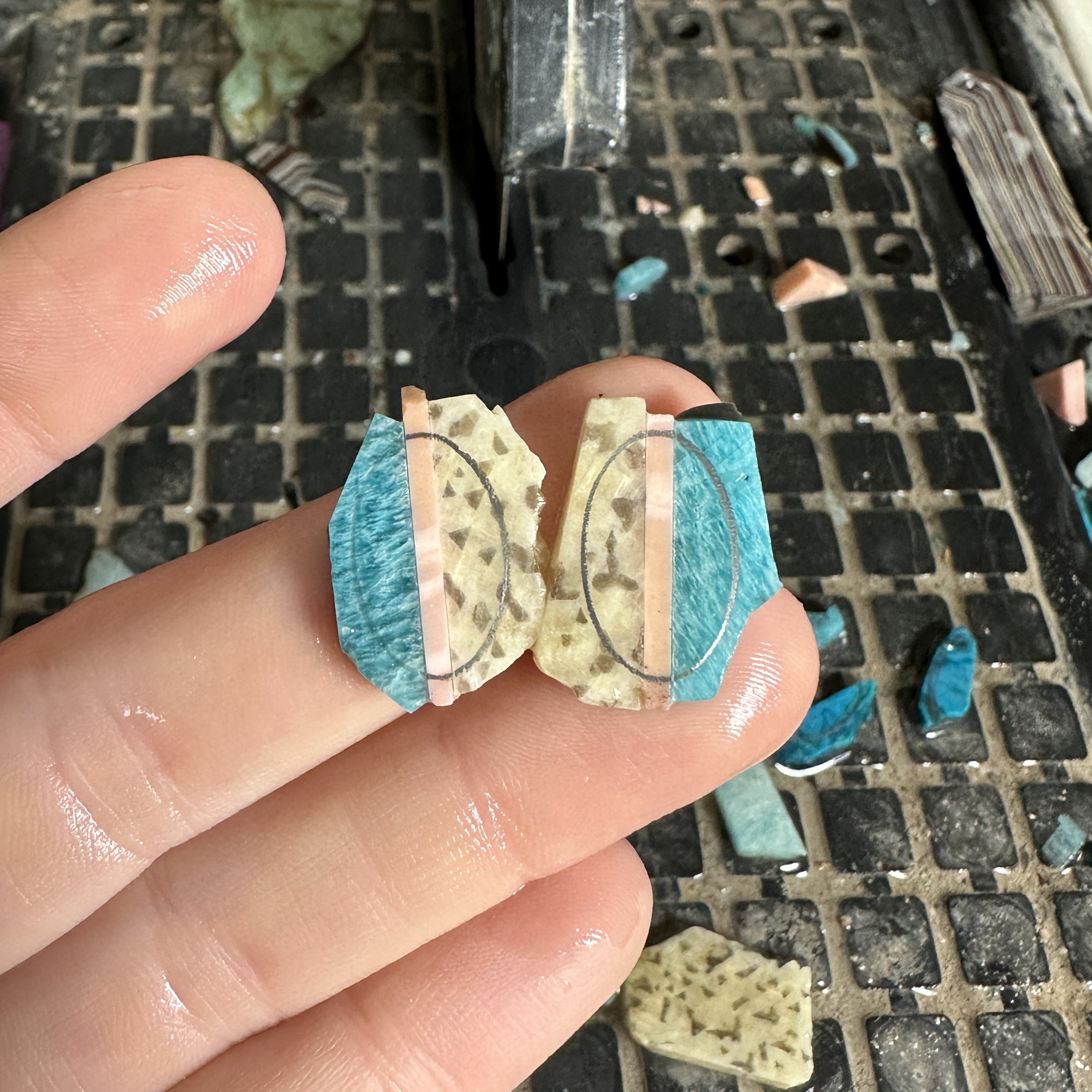 In-progress of shaping a stone intarsia for a pair of stud earrings