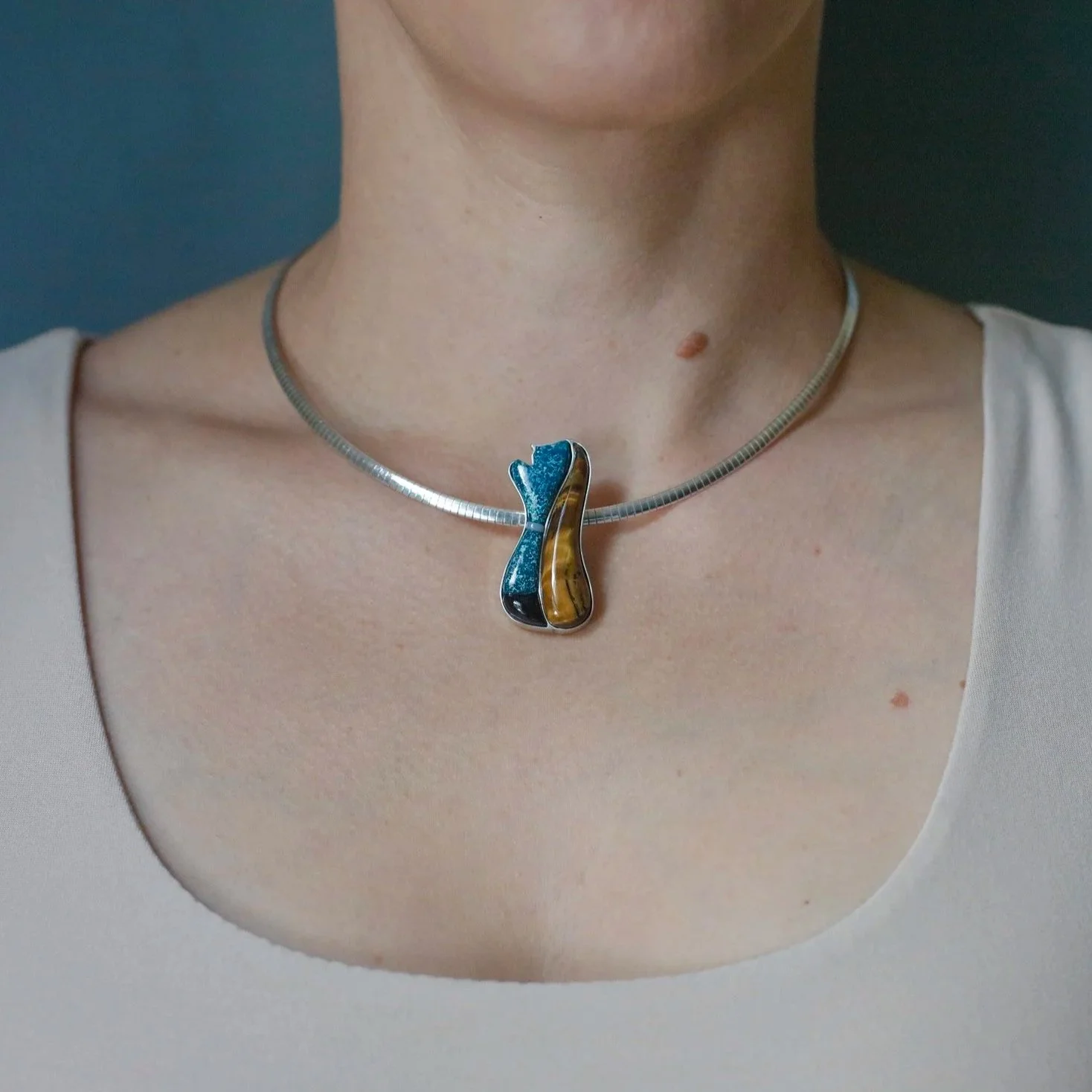 Spirit figurative cobblestone inlay pendant with hand-cut shattuckite, tigers eye, and other natural stones