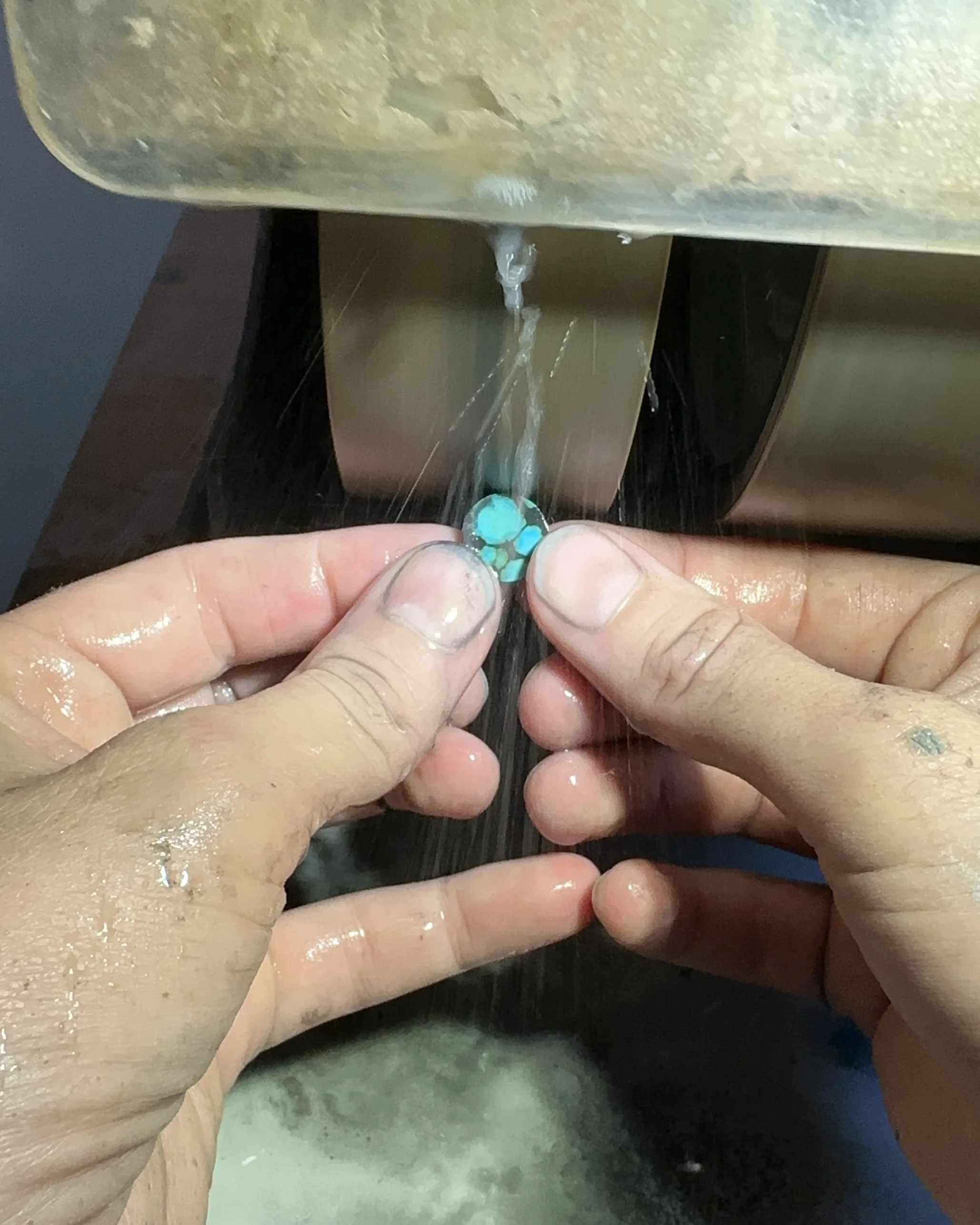 What is lapidary? Here, Caitlin Albritton is cutting a piece of Hubei turquoise for an inlay pendant, which is an example of one kind of lapidary art
