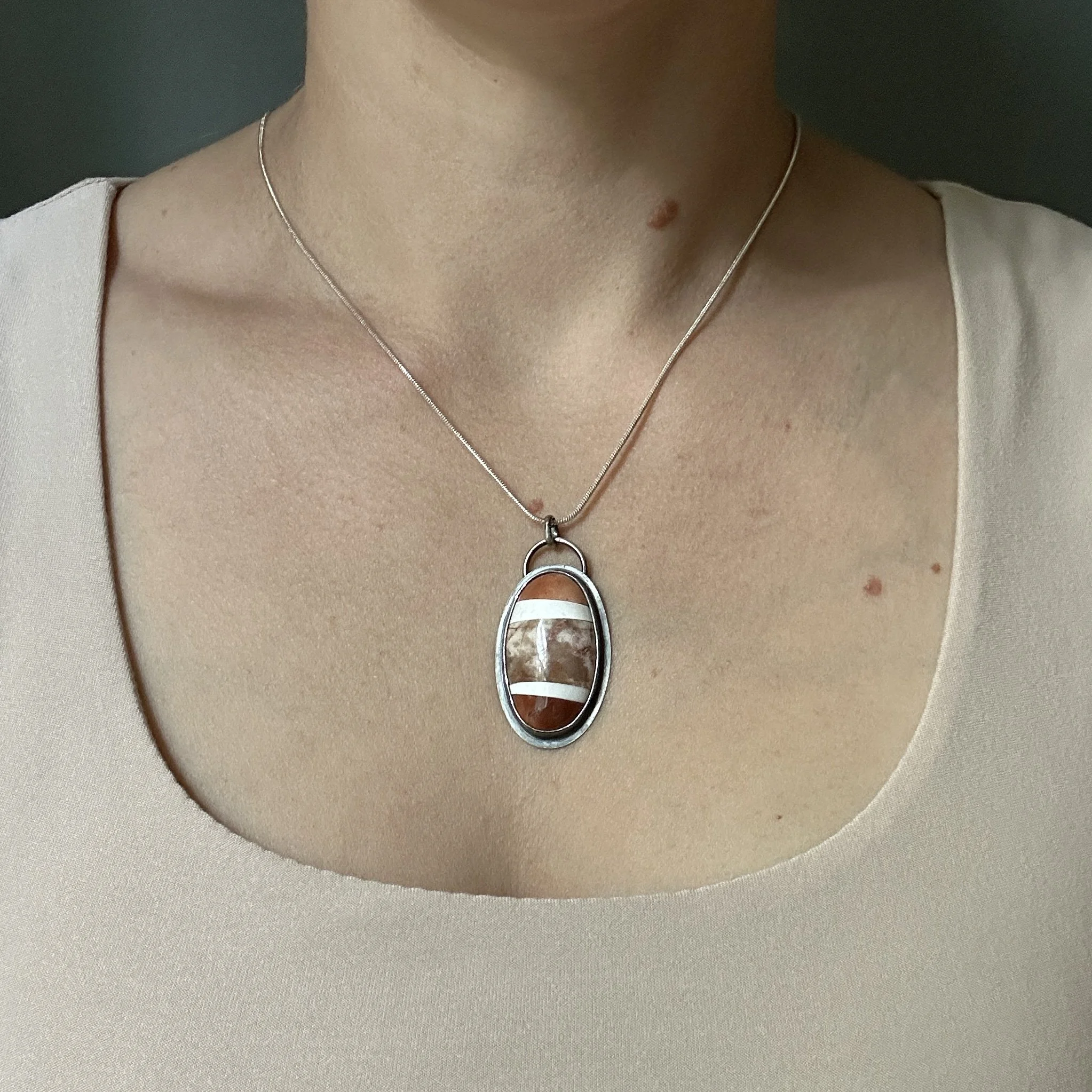 Florida agatized coral mosaic necklace set in sterling silver; modeled by the lapidary jewelry artist Caitlin Albritton