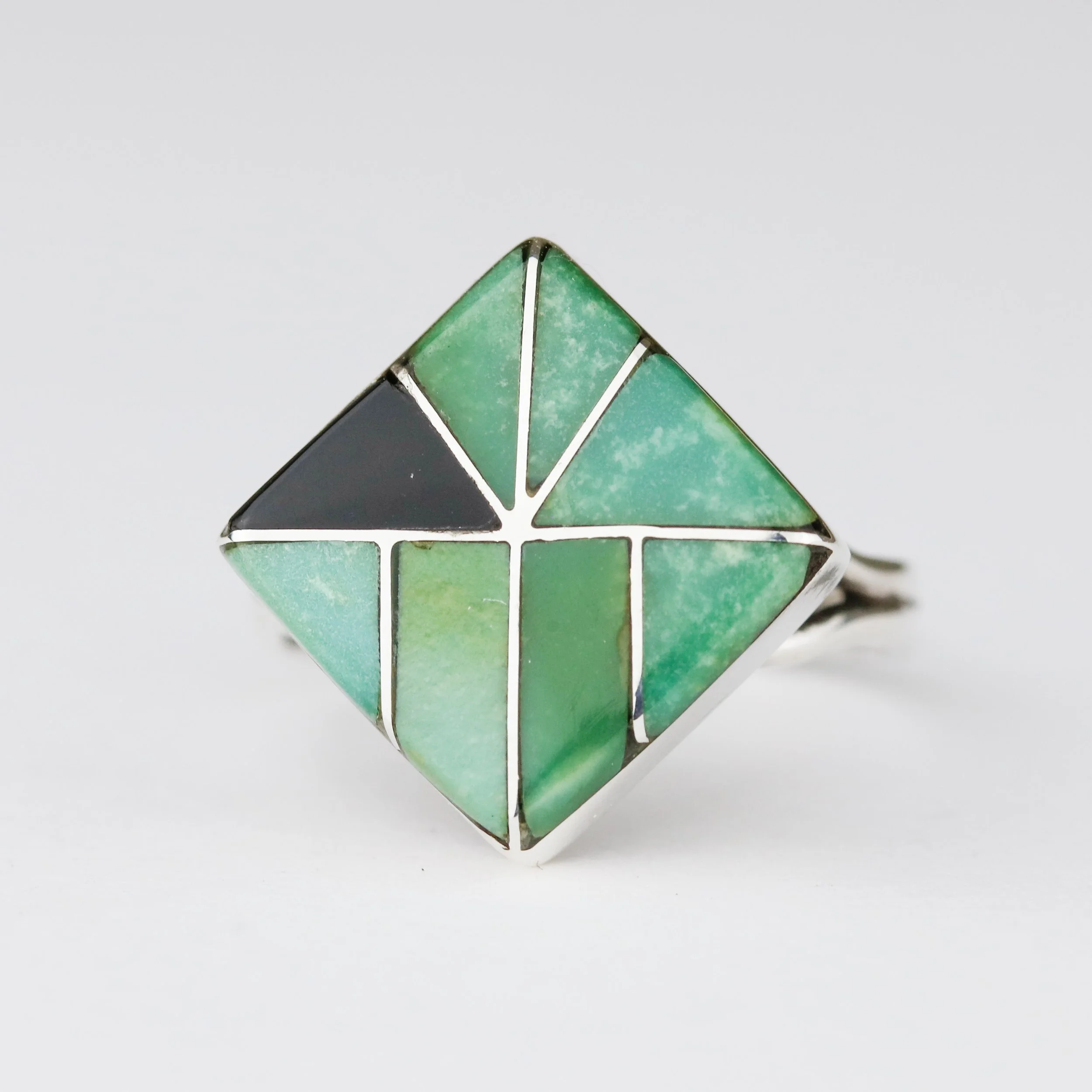 Instead of adding a piece of turquoise, I cut a piece of black onyx to add an off-centered abstract look to this beautiful geometric inlay ring.