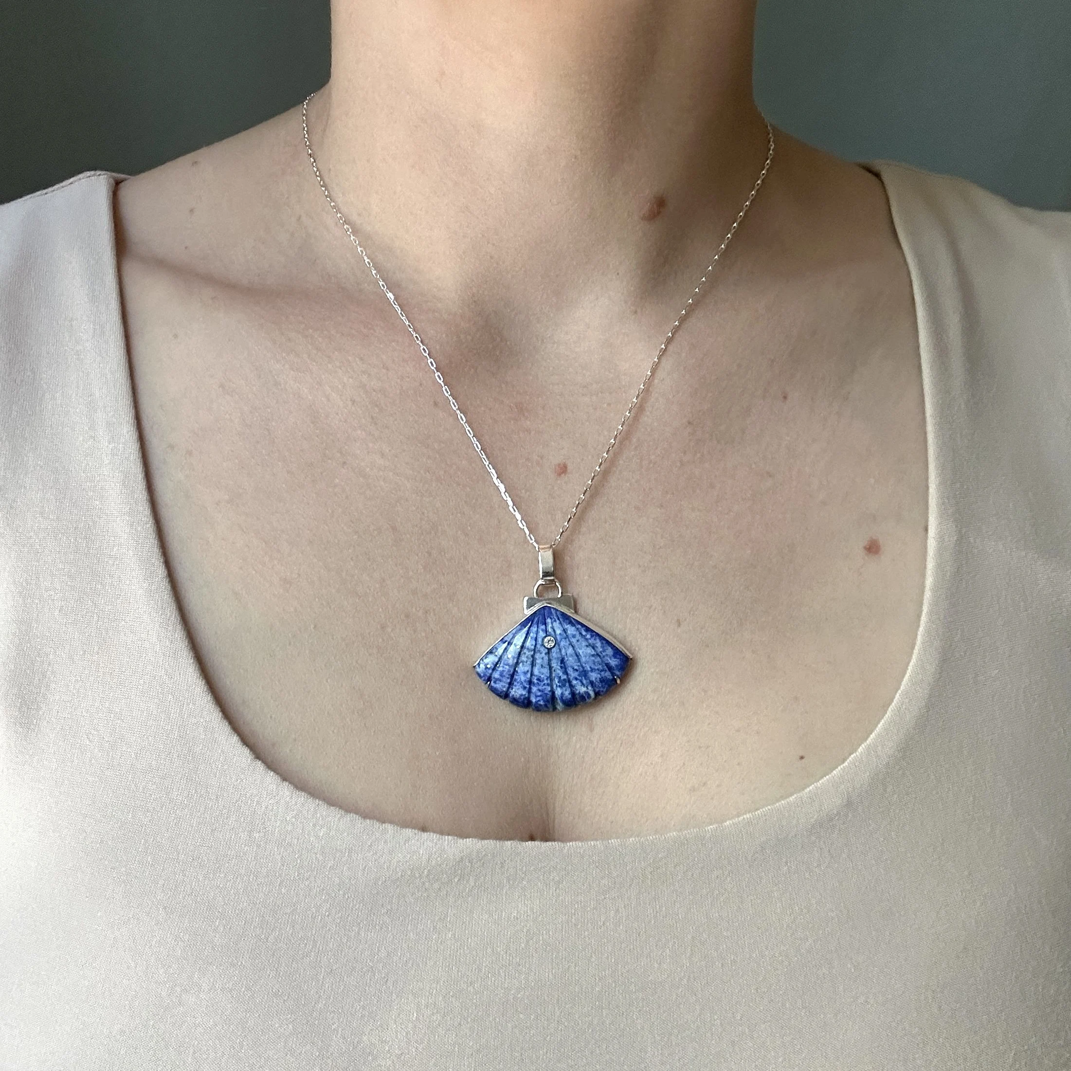 Lapis lazuli shell pendant, modeled by the jewelry artist