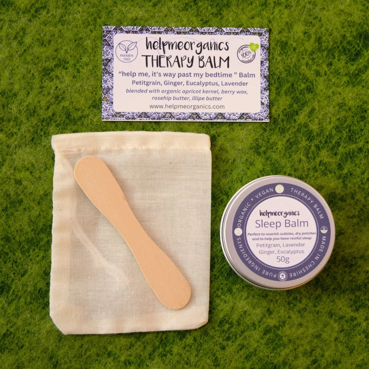 Organic sleep balm in a 50g aluminium tin with wooden spatula on a canvas bag