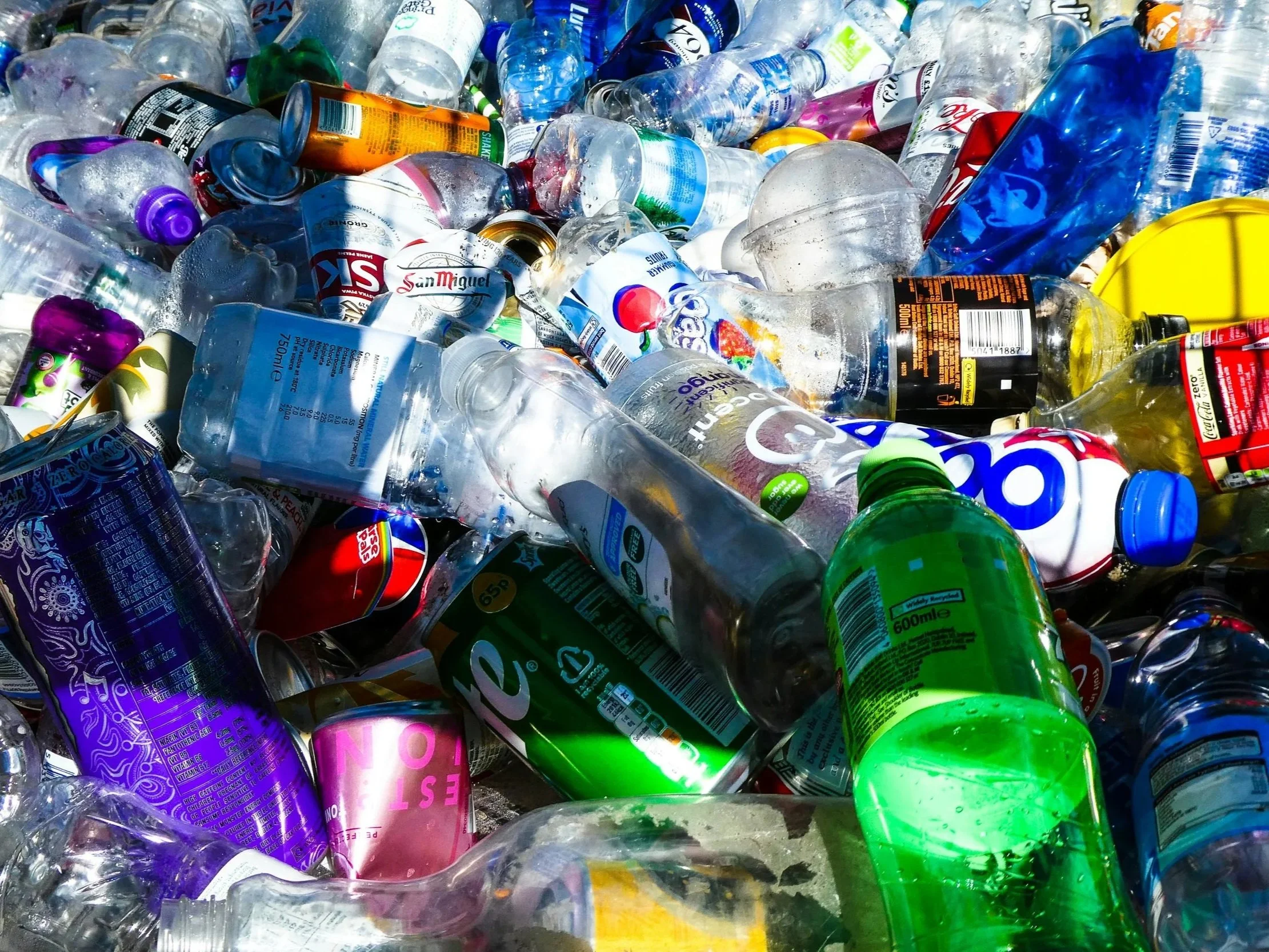 Plastic bottles and packaging waste piled together, showing the scale of waste generated during the Christmas season.