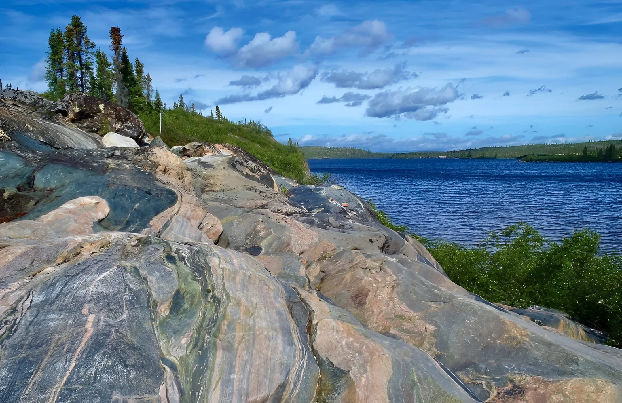Banded Acasta gneiss exposed along a remote lake in Canada’s Northwest Territories, showing some of Earth’s oldest 4 billion year old continental crust.