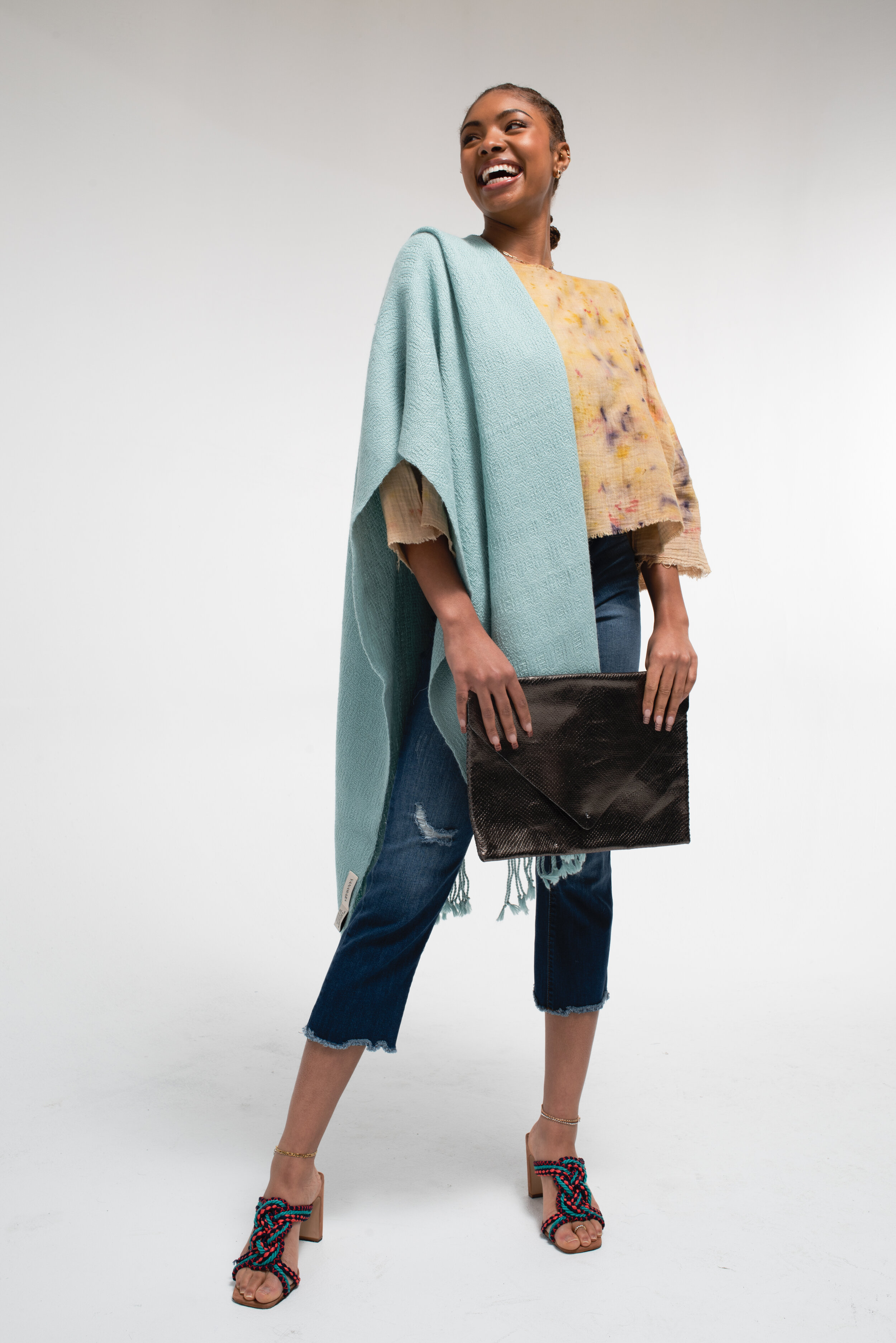 Model with shawl scarf (Yanawara), organic cotton plant dye shirt (I Wander Through), and upcycled leather purse (Volta Atelier). Creative Directing and Wardrobe Styling by Marly Barraza of Mar Design Studio.