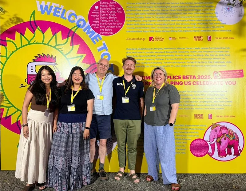 A picture of a group of people in front of a large yellow sign with text on it. The group is the Asia New Zealand Foundation delegation at Splice Beta, Thailand, in 2025