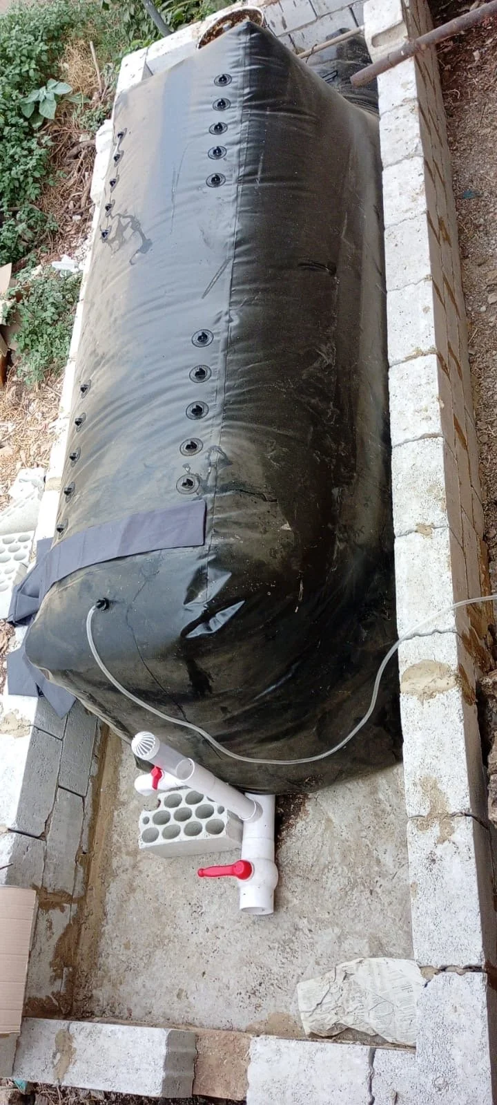 Compost pile covered with plastic