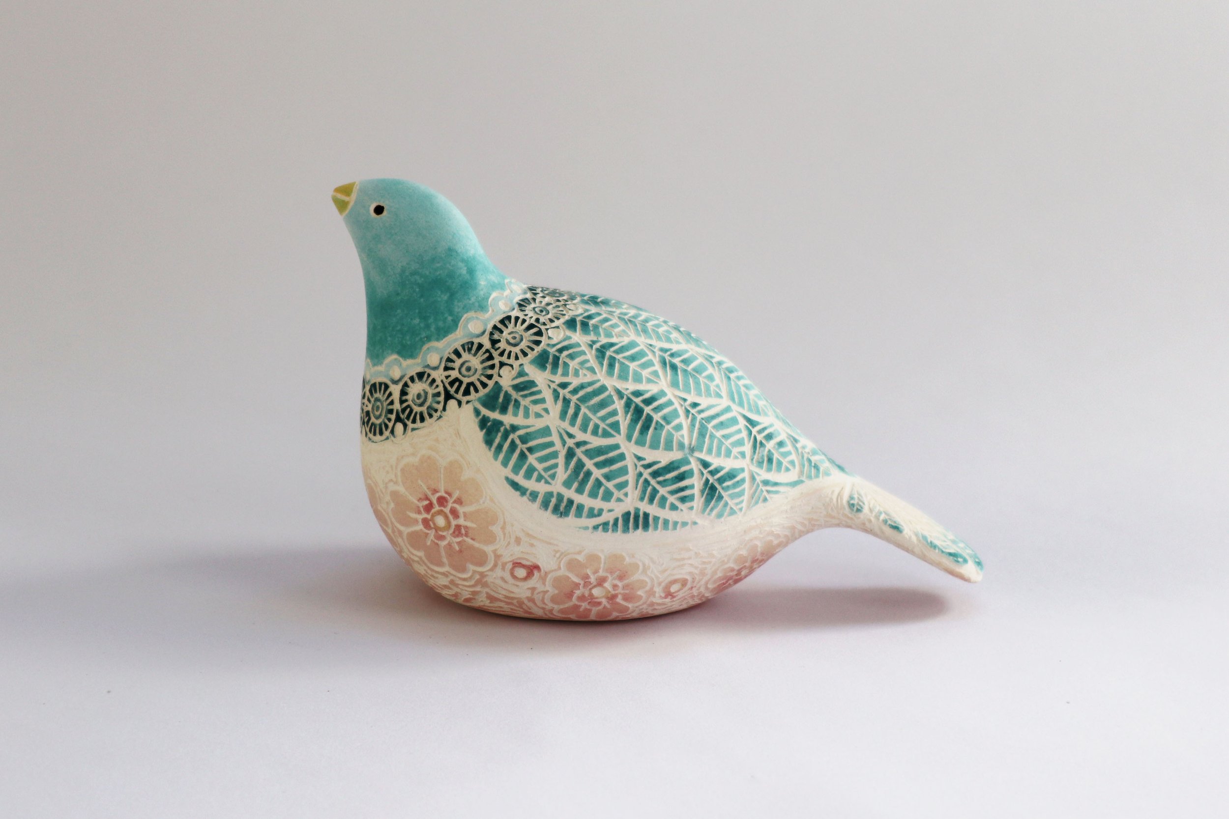 Slip cast bird, coloured with underglazes and sgraffito