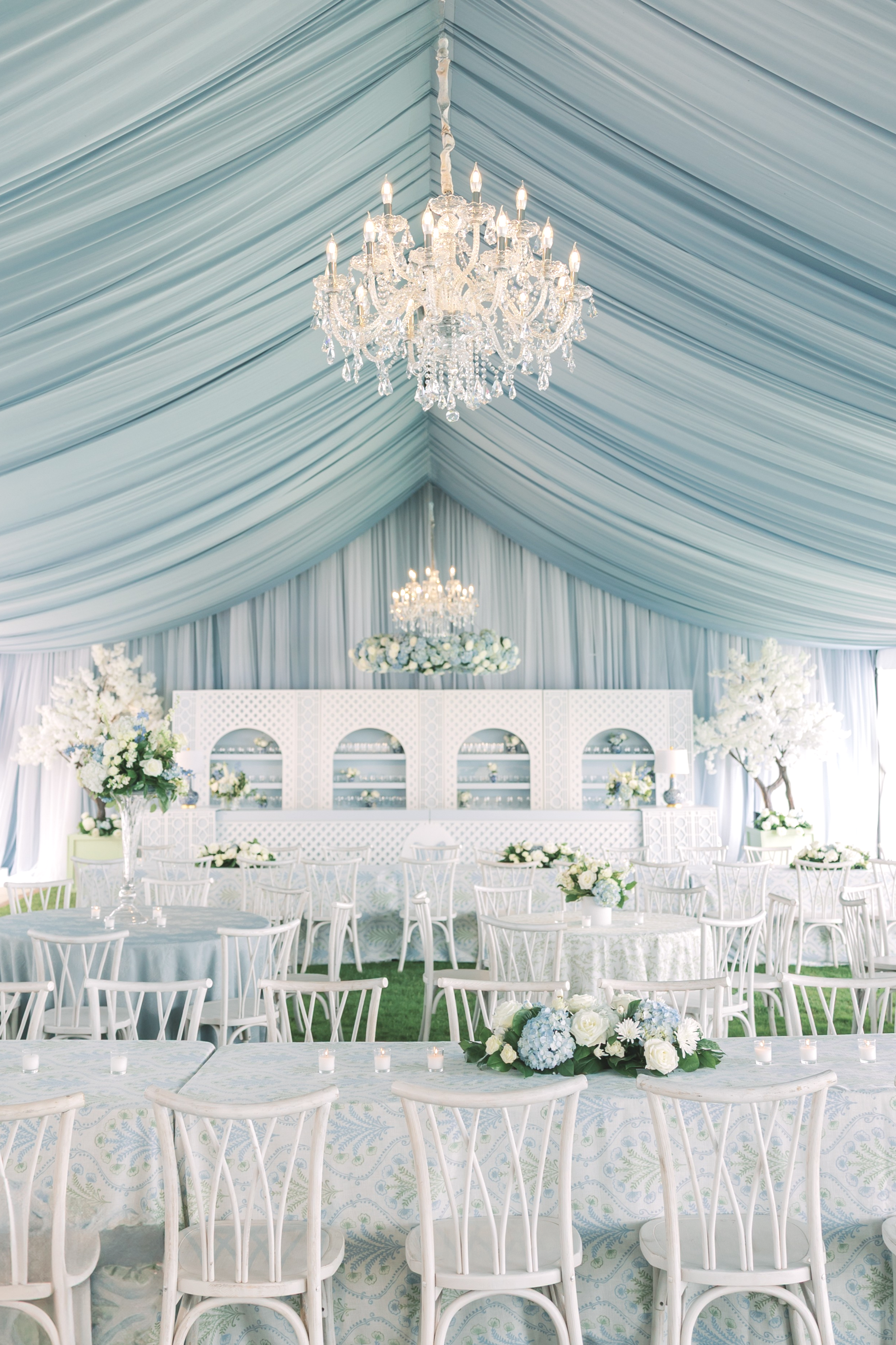 Featuring our Dusty Blue Spandex Ceiling draping and our XL Crystal Chandeliers, as well as our 5' Steel Floral Ring.