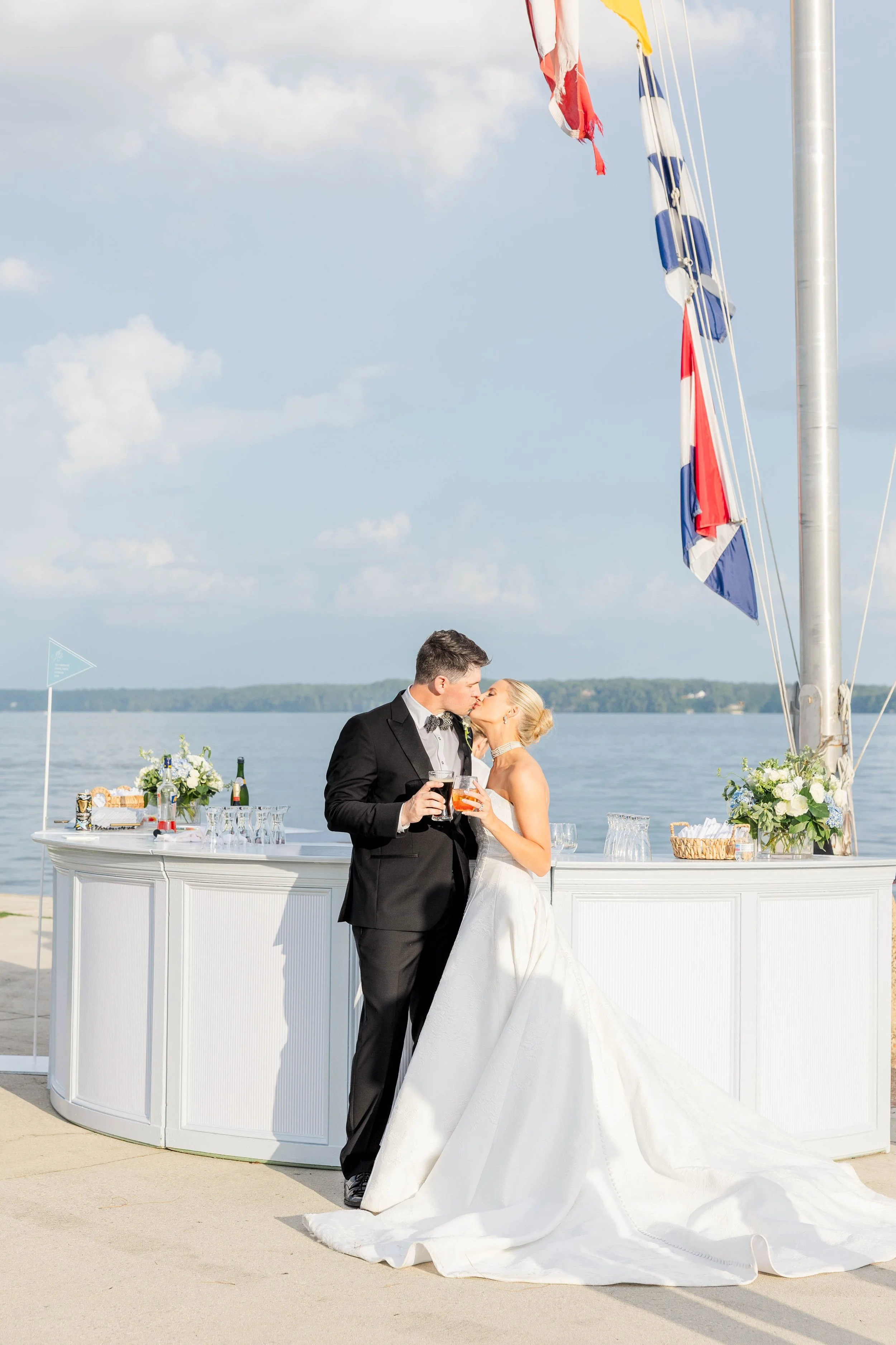 Wedding celebration beside a white event bar on the waterfront