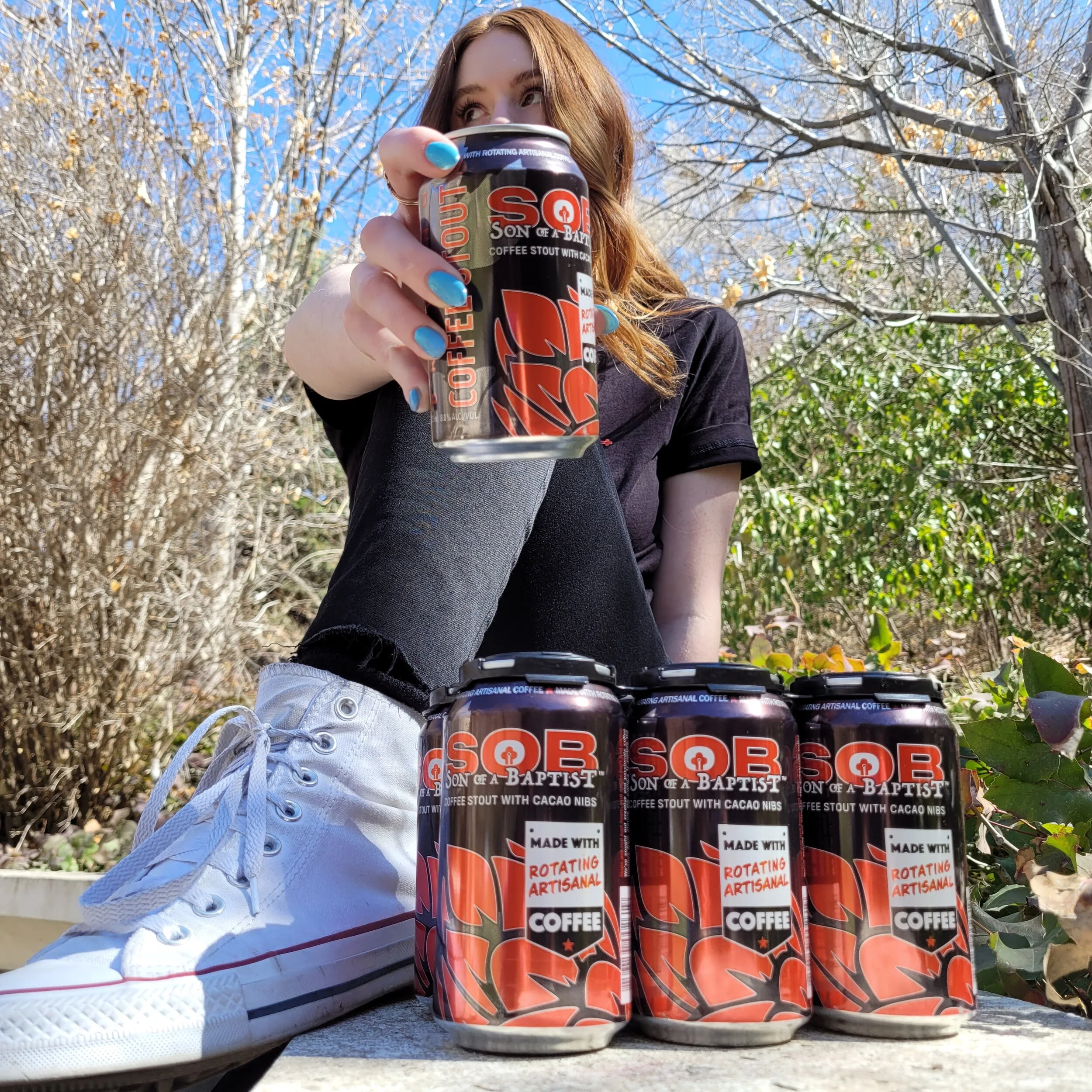 A woman with a six pack of Son of a Baptist