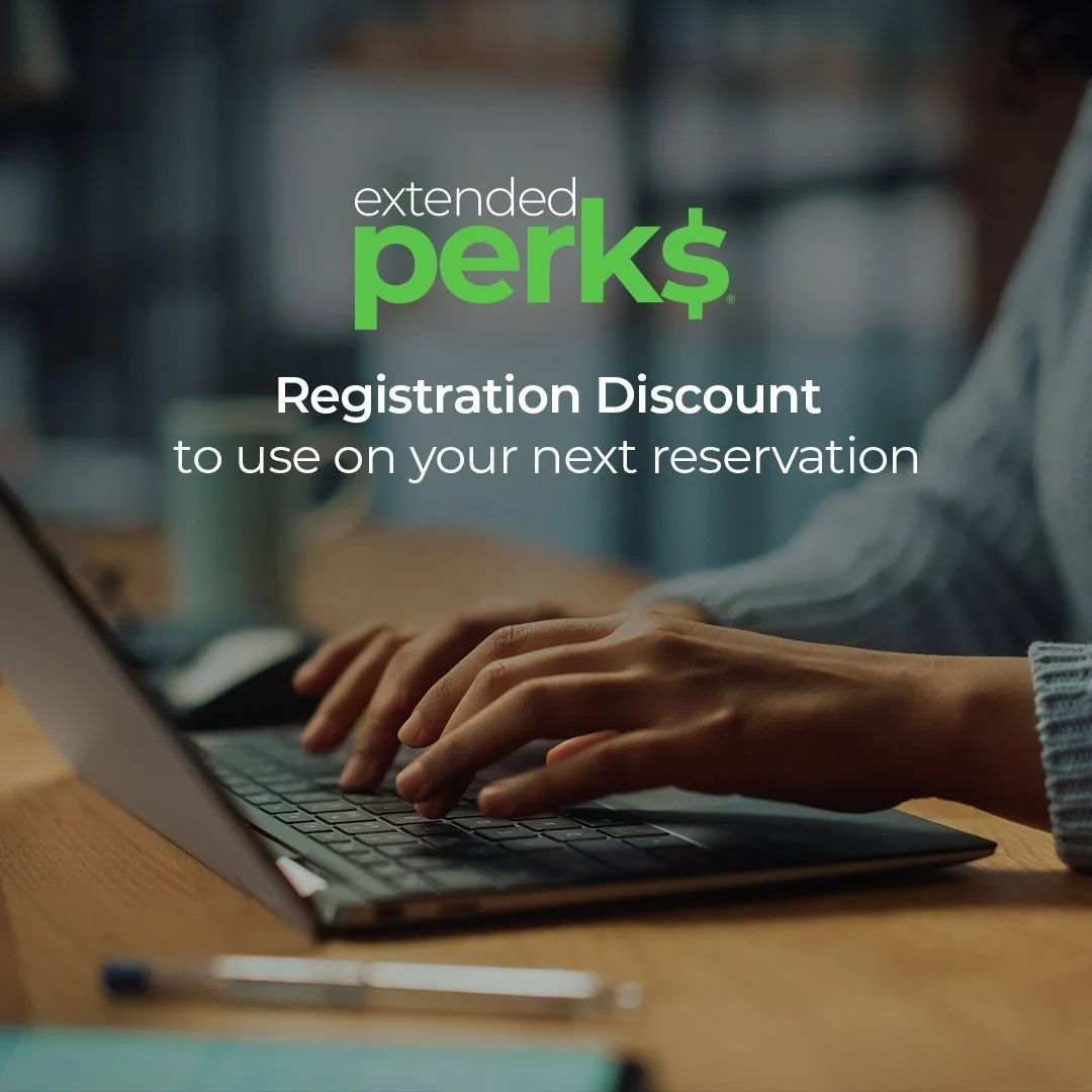 Close-up of a person's hands typing on a laptop keyboard with a blurred background. Overlaid text reads 'extended perks', 'Registration Discount', and 'to use on your next reservation'.
