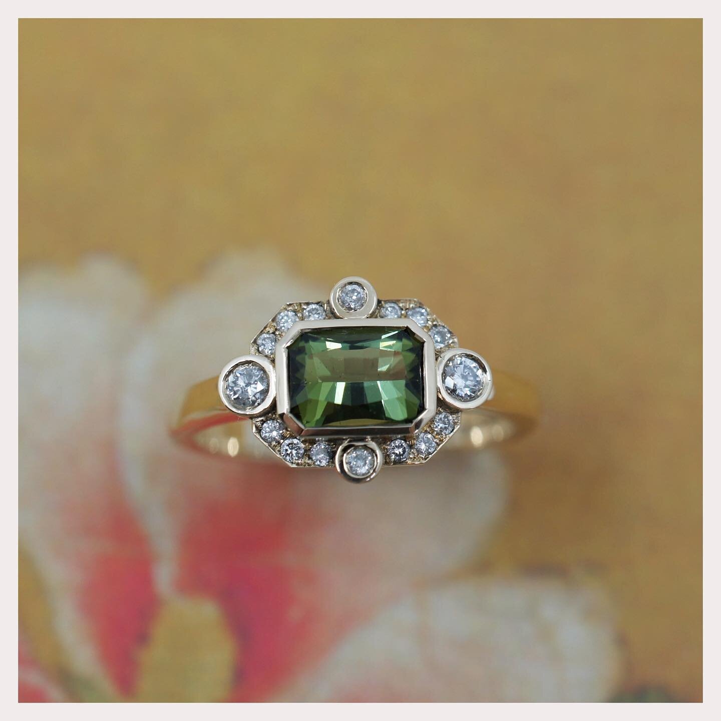 A barion cut jungle green tourmaline, set into this decorative diamond cluster ring 💫 

We worked with Jane to create a bespoke ring to celebrate her birthday, incorporating some family jewellery of hers ✨ 

Swipe to see the before and some of the m