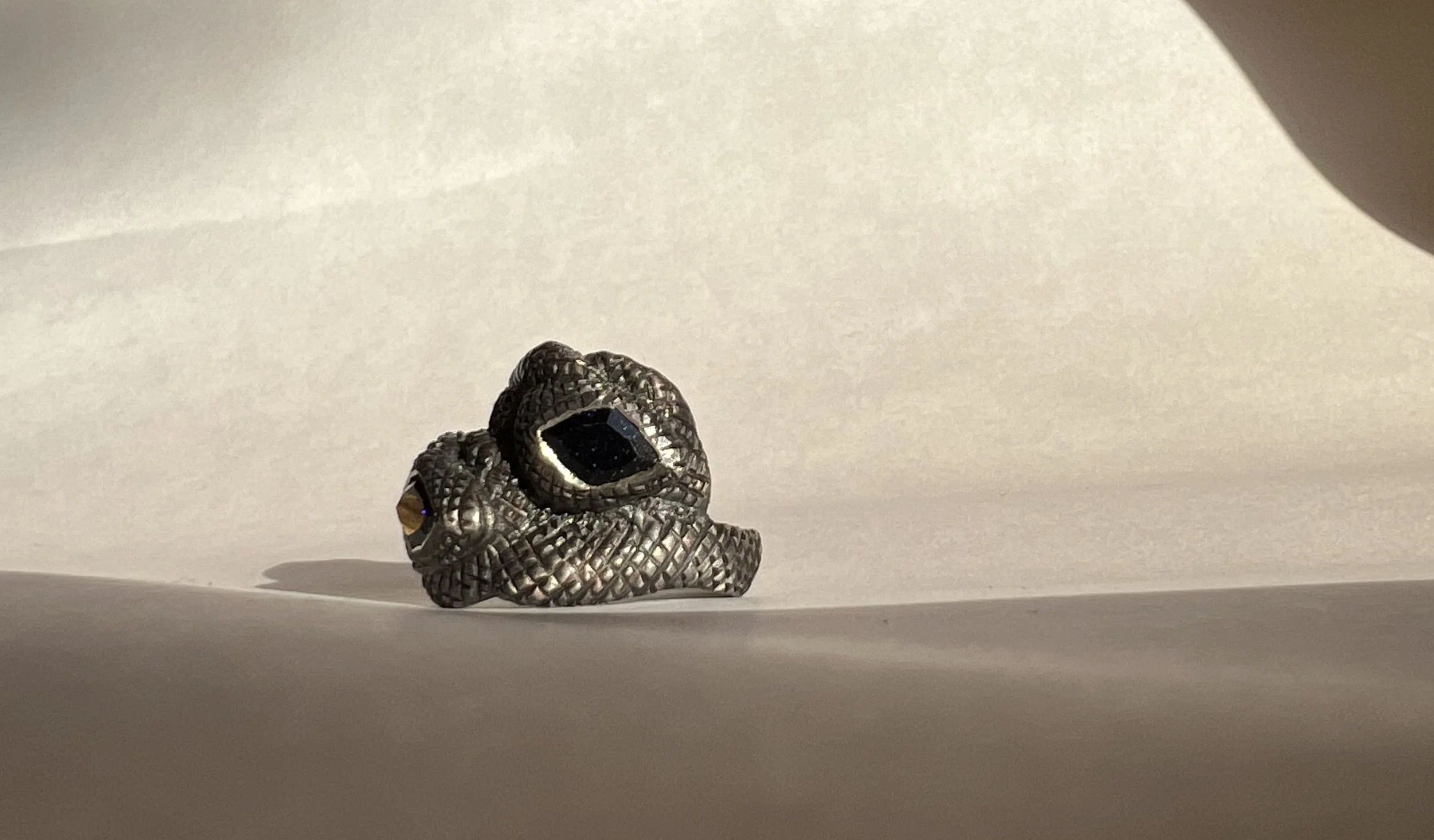 Oxidized sterling silver ring with gold stones