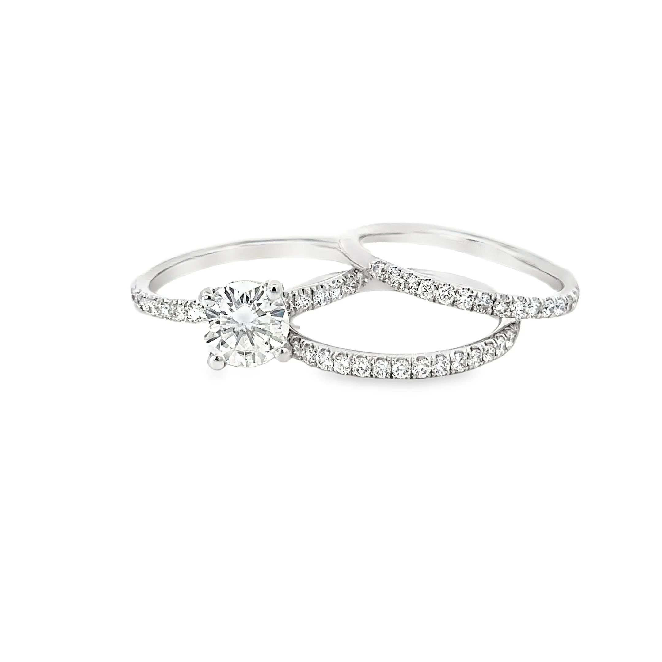 Three silver rings with small diamonds, one with a large central diamond, arranged in a row on a white background.