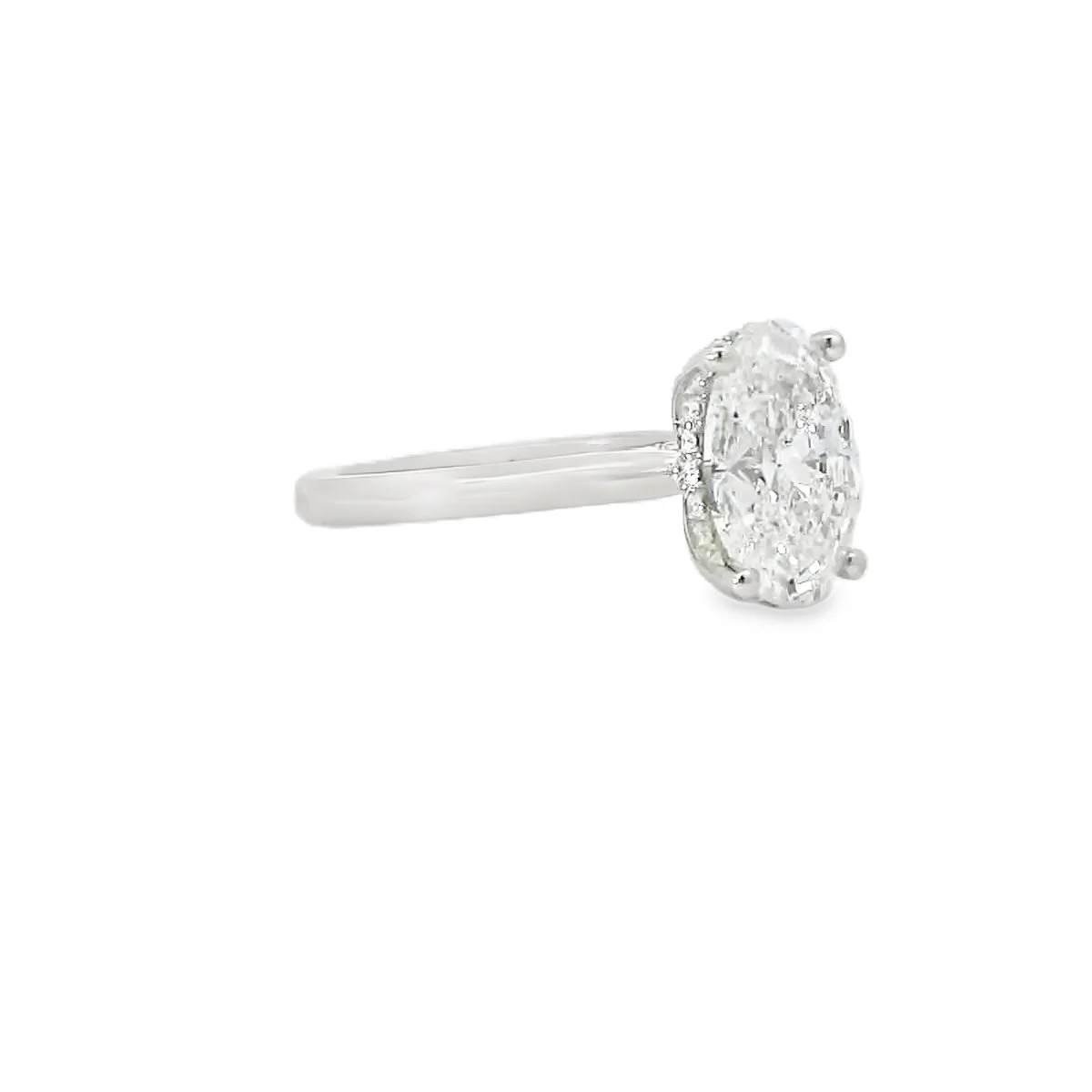 Silver ring with an oval-shaped diamond in a prong setting.