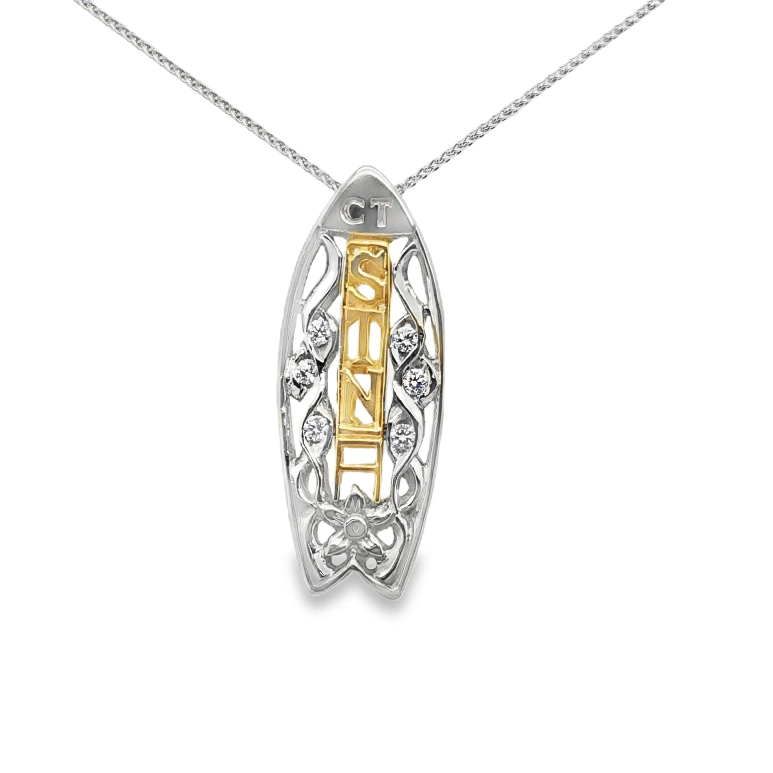 Silver necklace with a pendant featuring a gold-colored vertical bar with the word 'ALOHA' and a silver ornate border, with some embedded small clear stones.