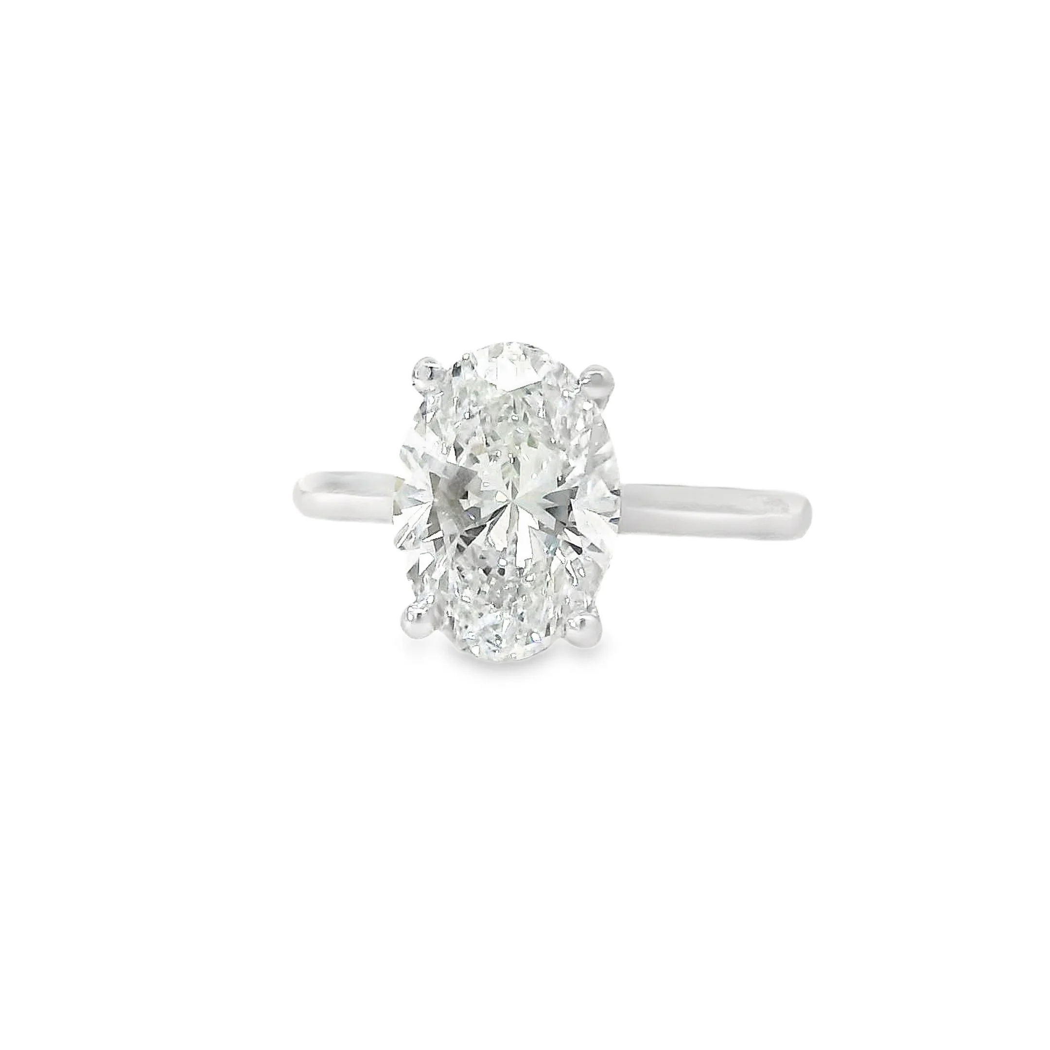 Elegant silver ring with an oval-shaped diamond center and smaller diamonds on the sides, set against a plain white background.