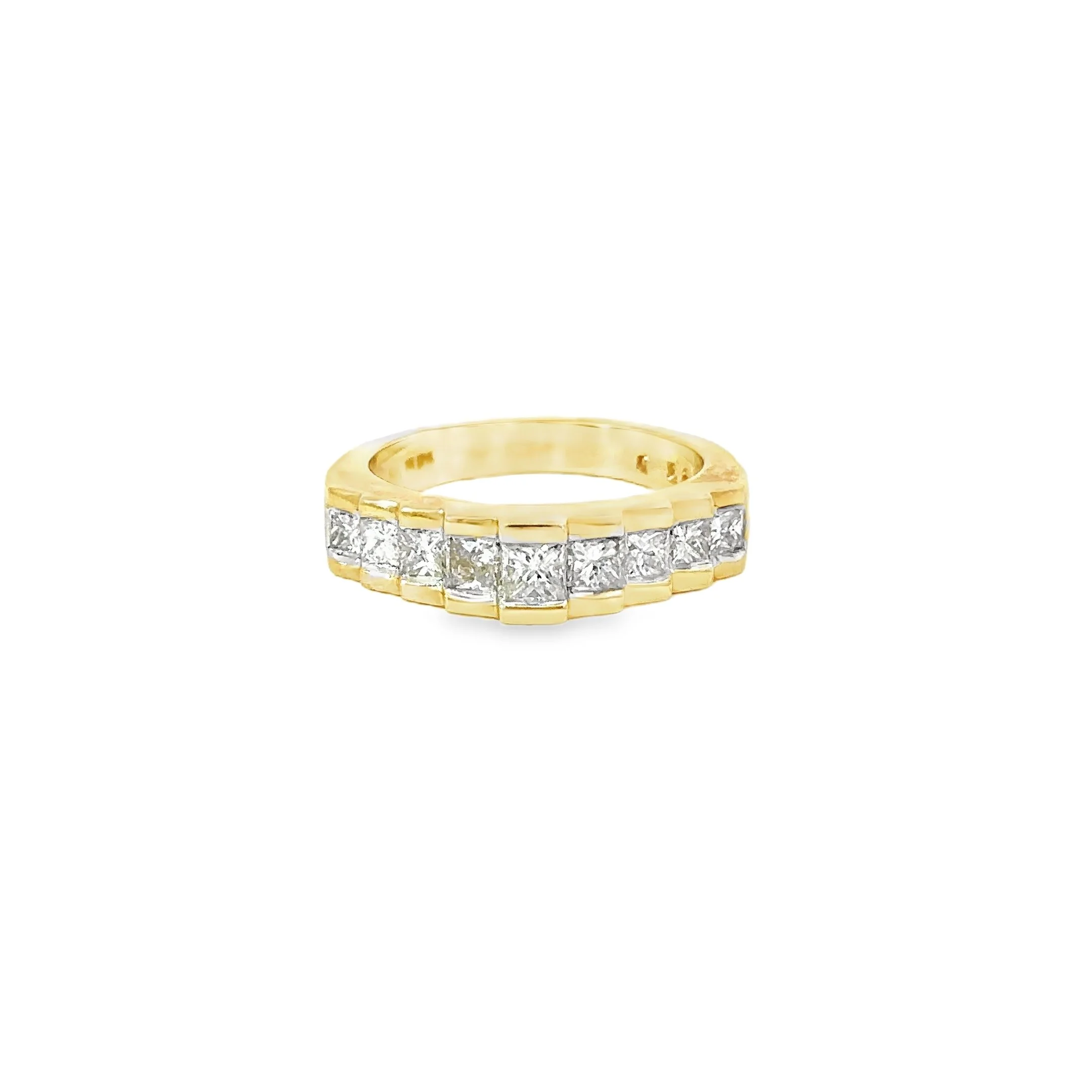 Gold ring with a row of large, square-cut diamonds set along the band on a white background.