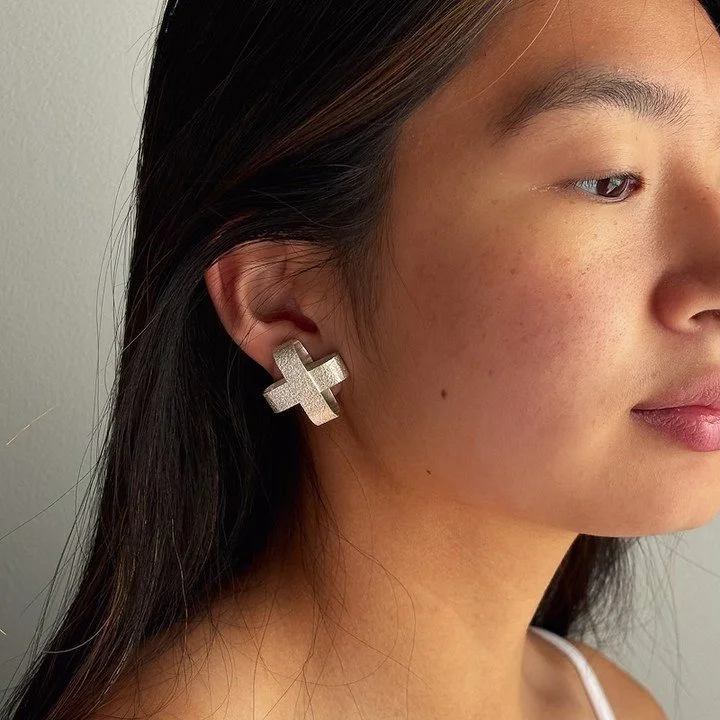 Sterling silver three dimensional ✖︎ posts. Frosty white finish.