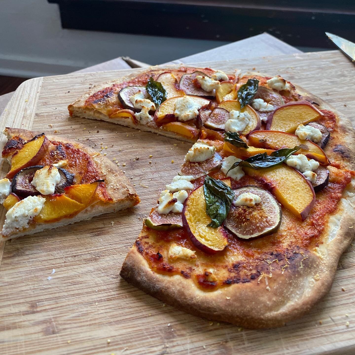 Eric cooking. Peach, fig, and goat cheese pizza. #pizza #figs #homecooking