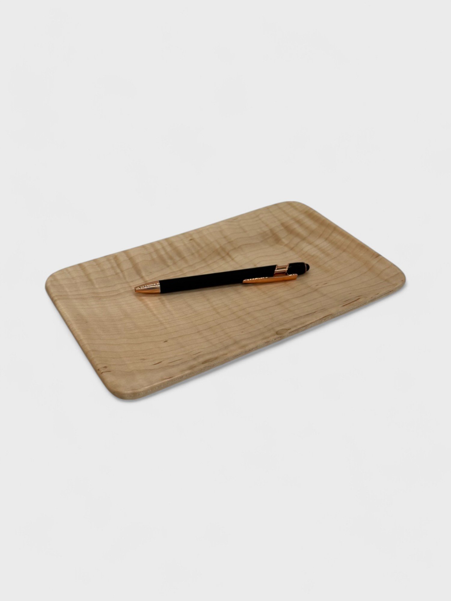 a small tray made from Maple wood with a pen on it
