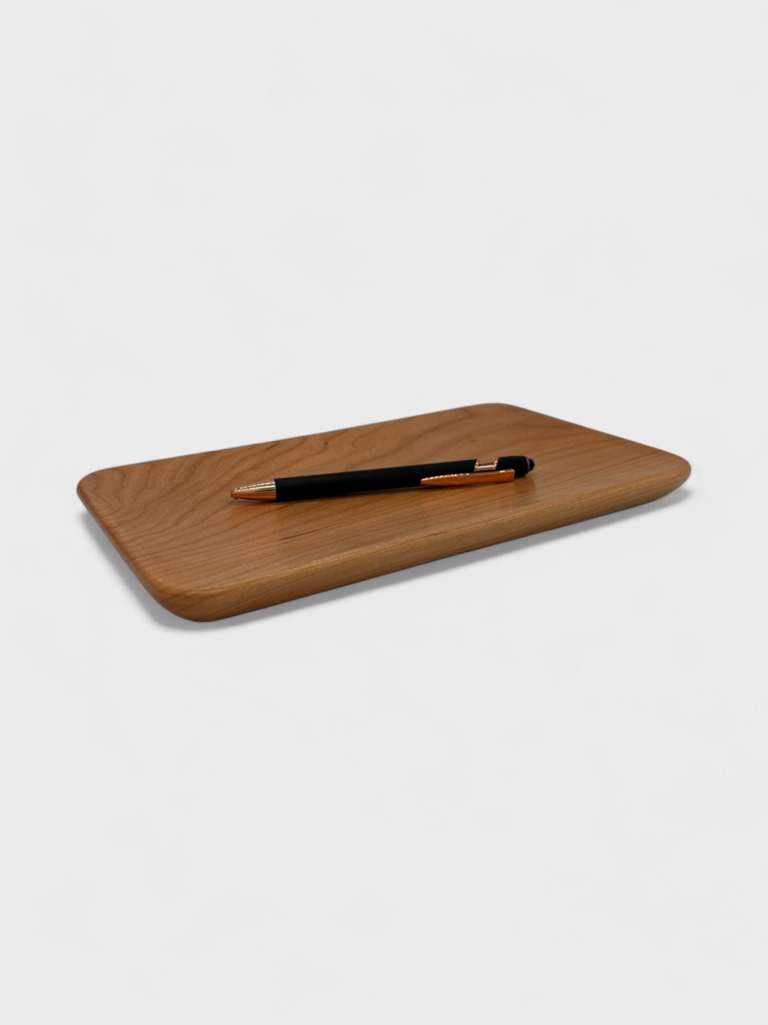 a small tray made from Cherry wood with a pen on it