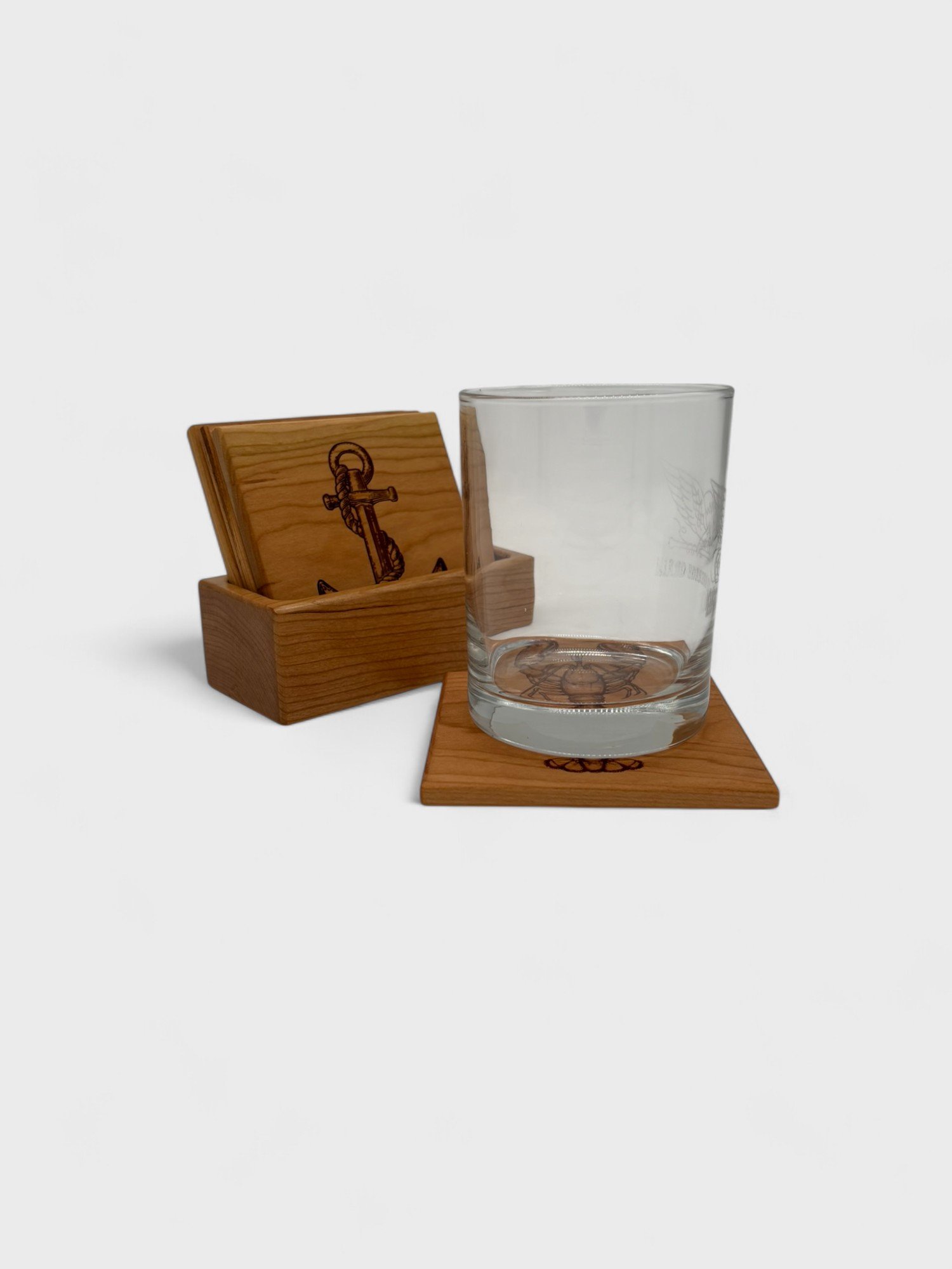 a set of nautical themed wooden coasters made of cherry wood