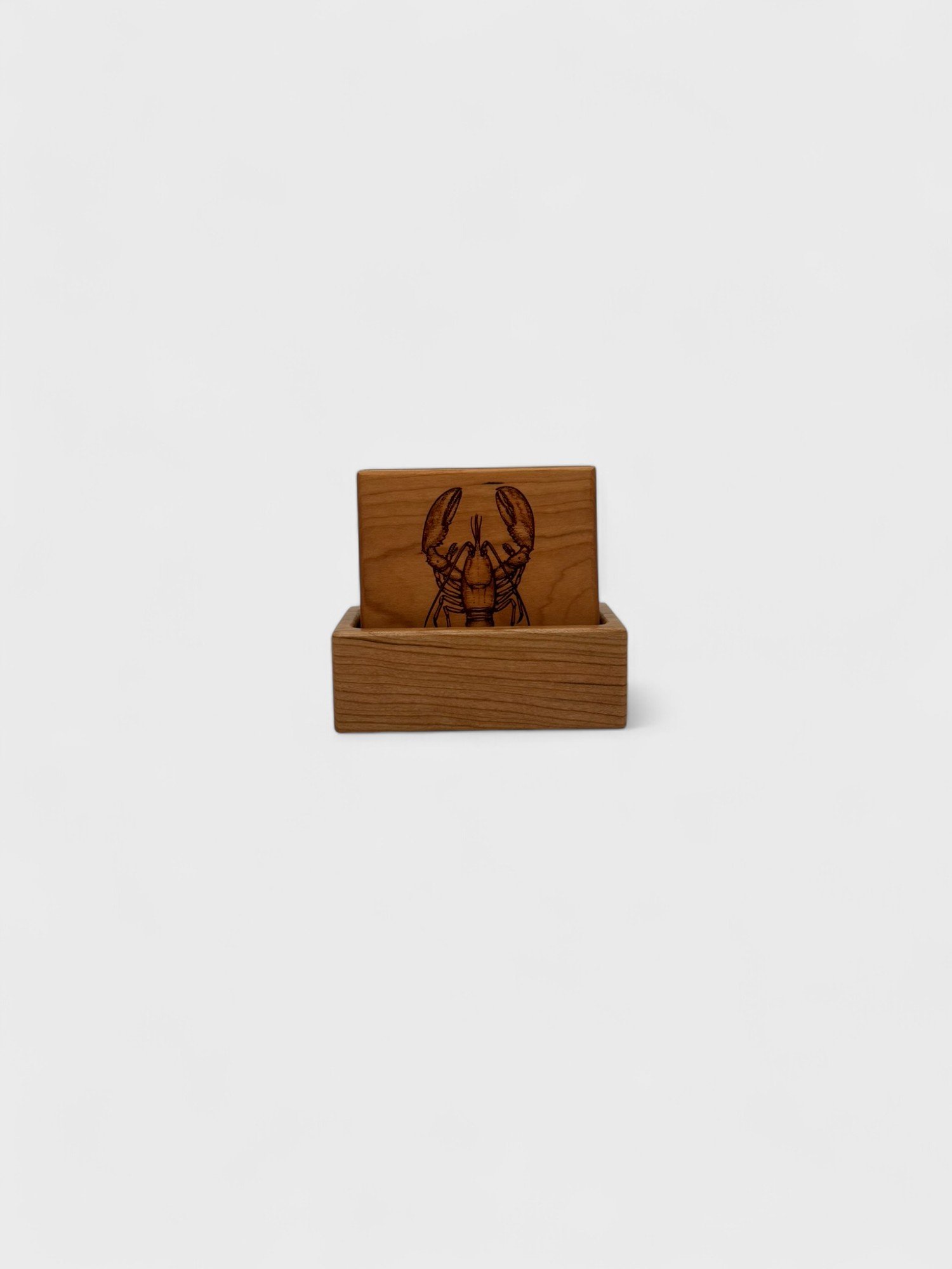 a set of nautical themed wooden coasters made of cherry wood