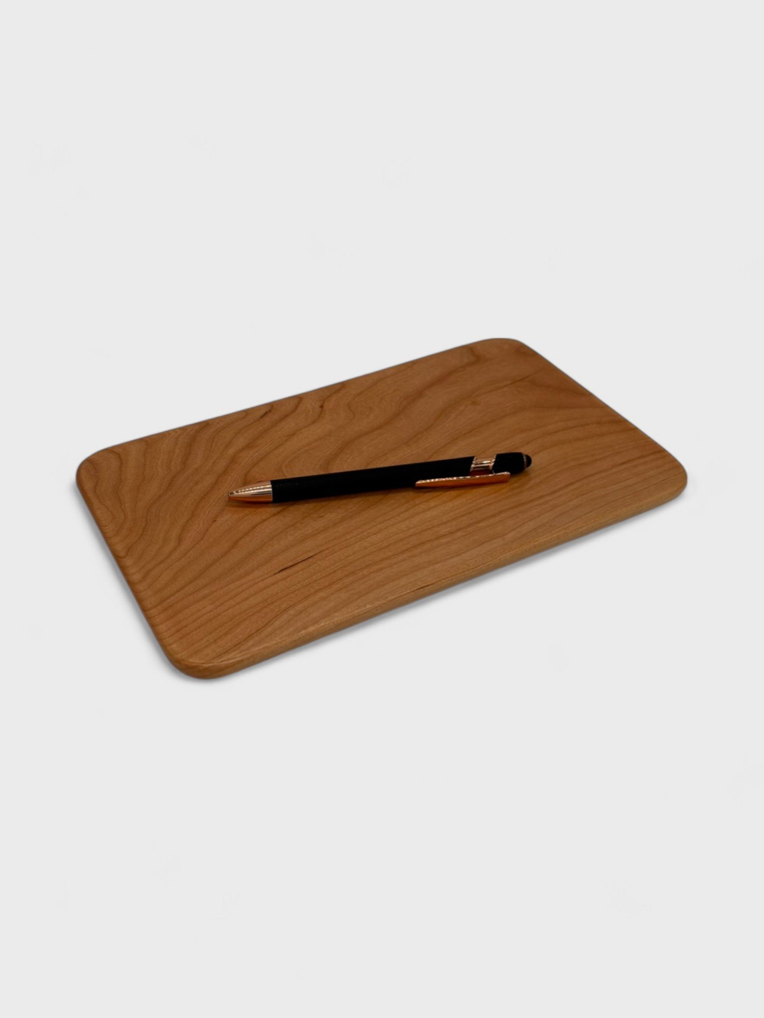 a small tray made from Cherry wood with a pen on it