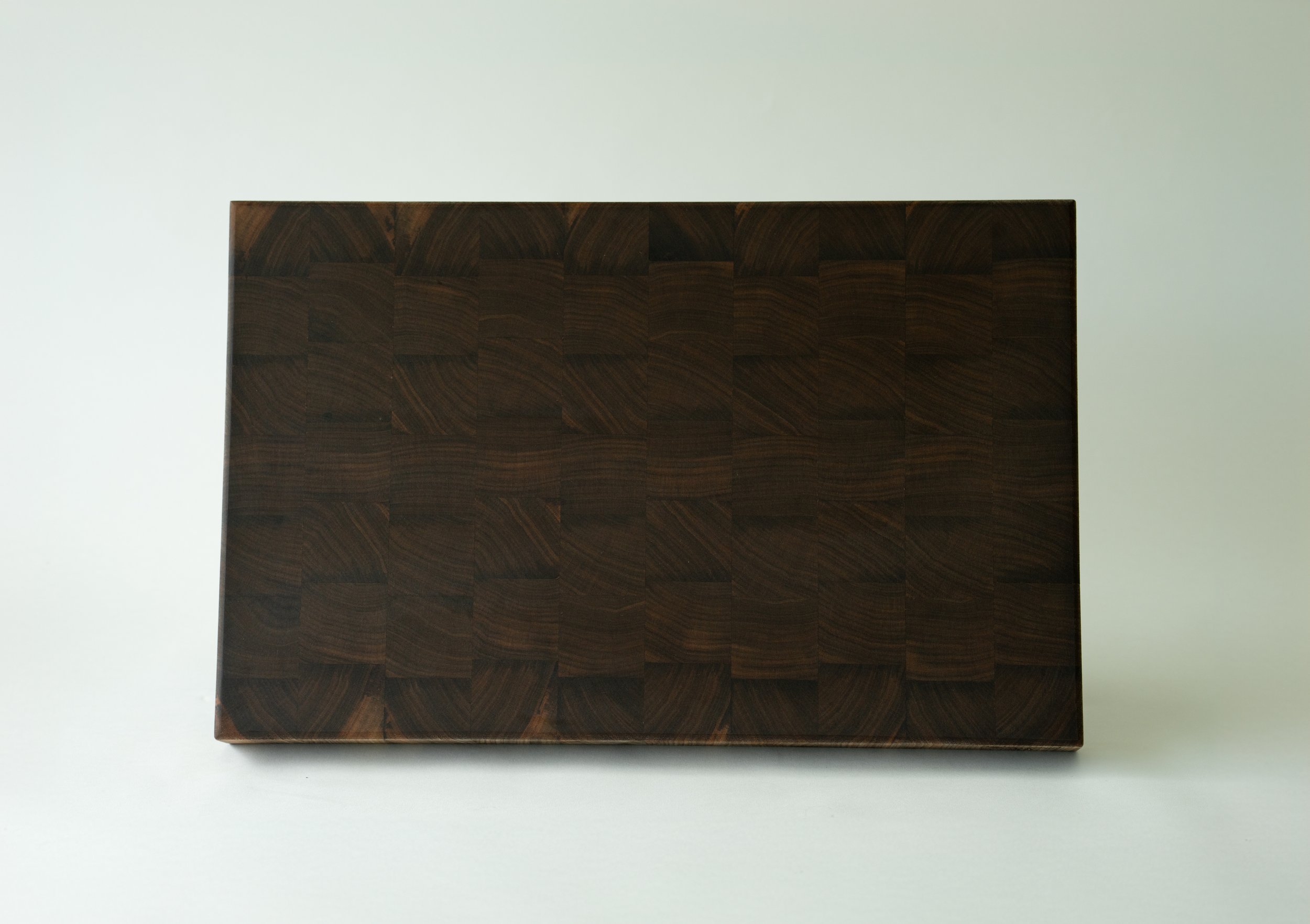 a cherry end grain cutting board made from walnut wood