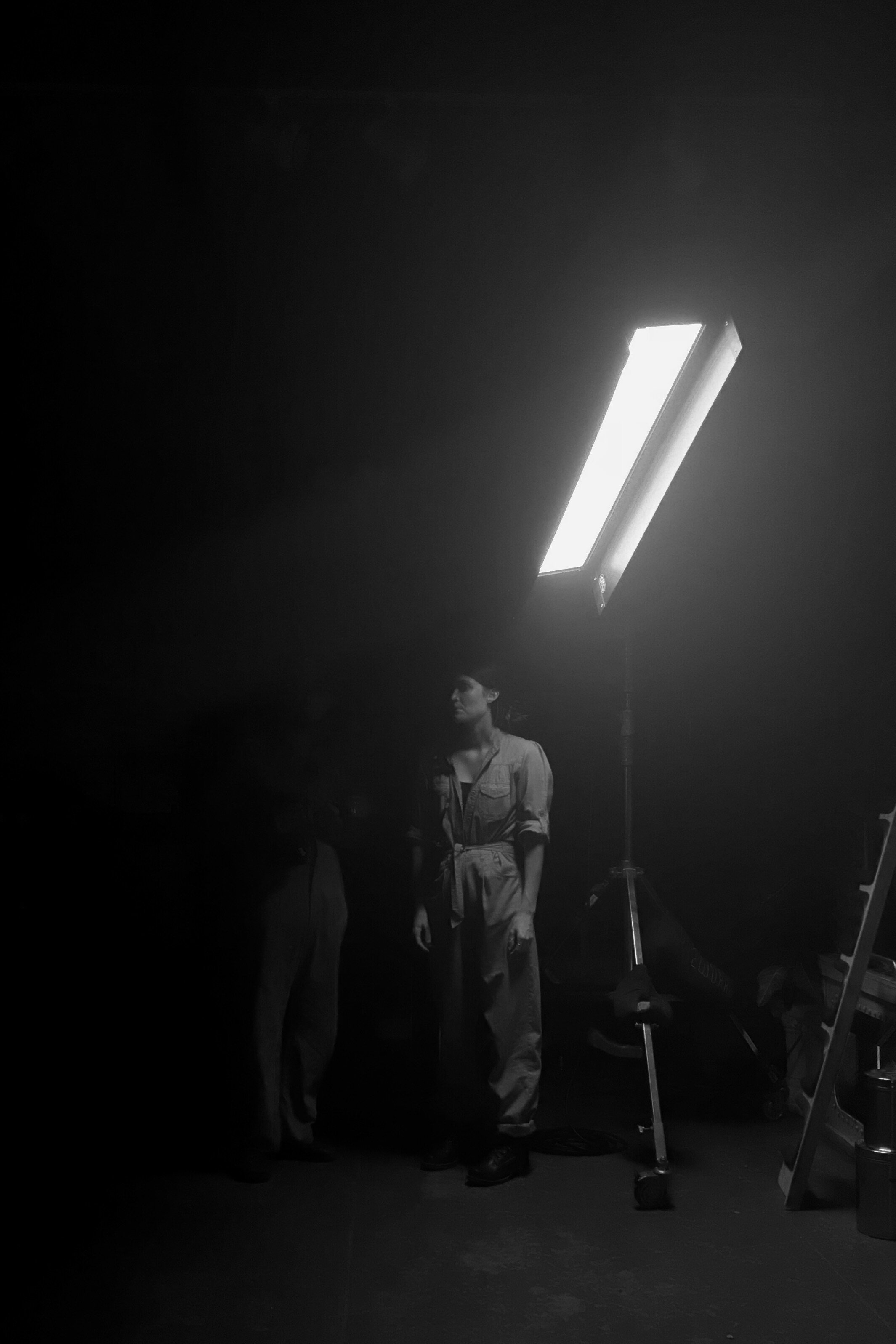 Los Angeles, CA. An art department set dresser finds her own light while setting up a scene.