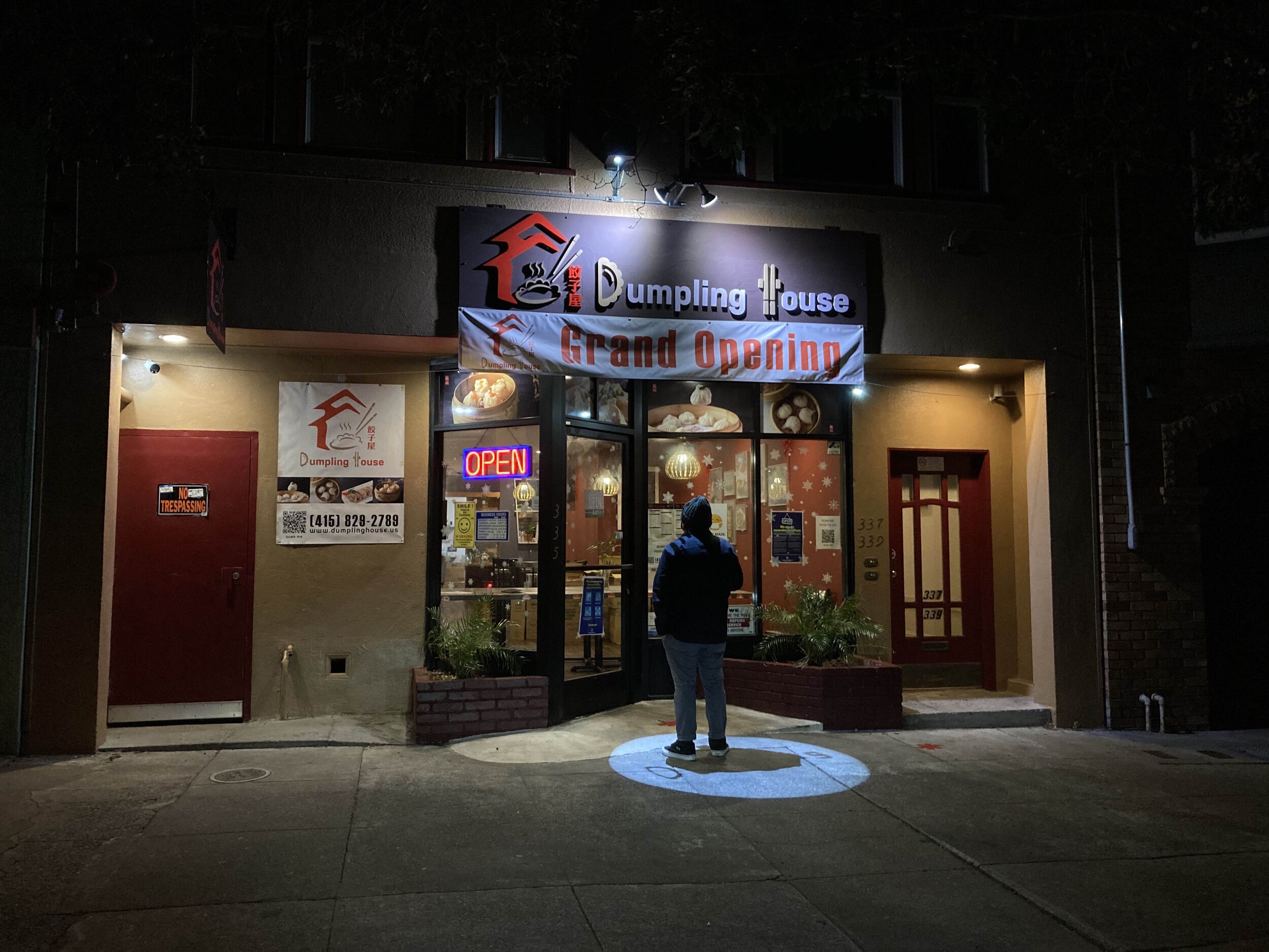 San Francisco, CA. A man on the hunt for the best dumplings in town peruses a menu.