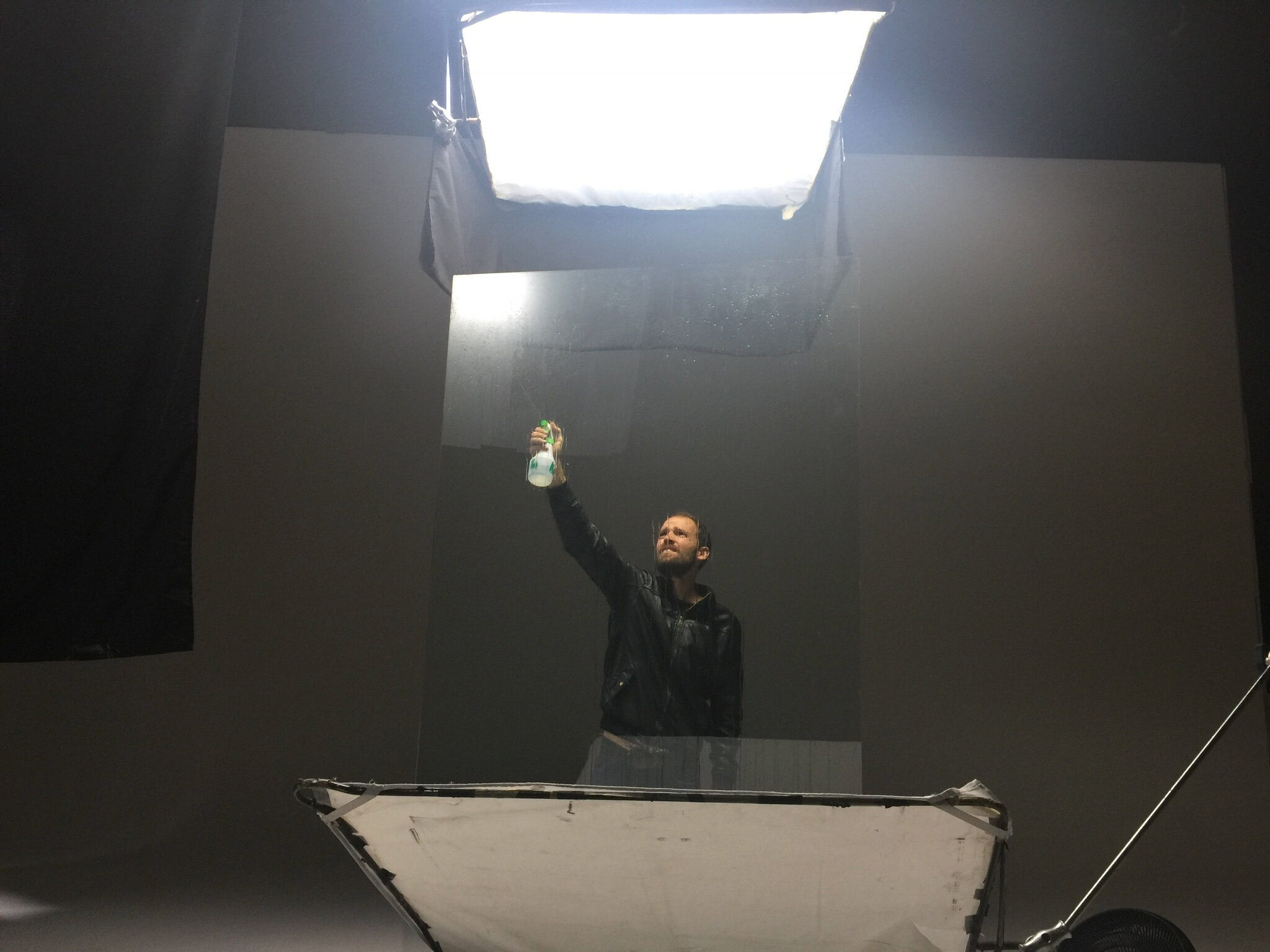Mexico City. An art director cleans glass for the next special effects take.