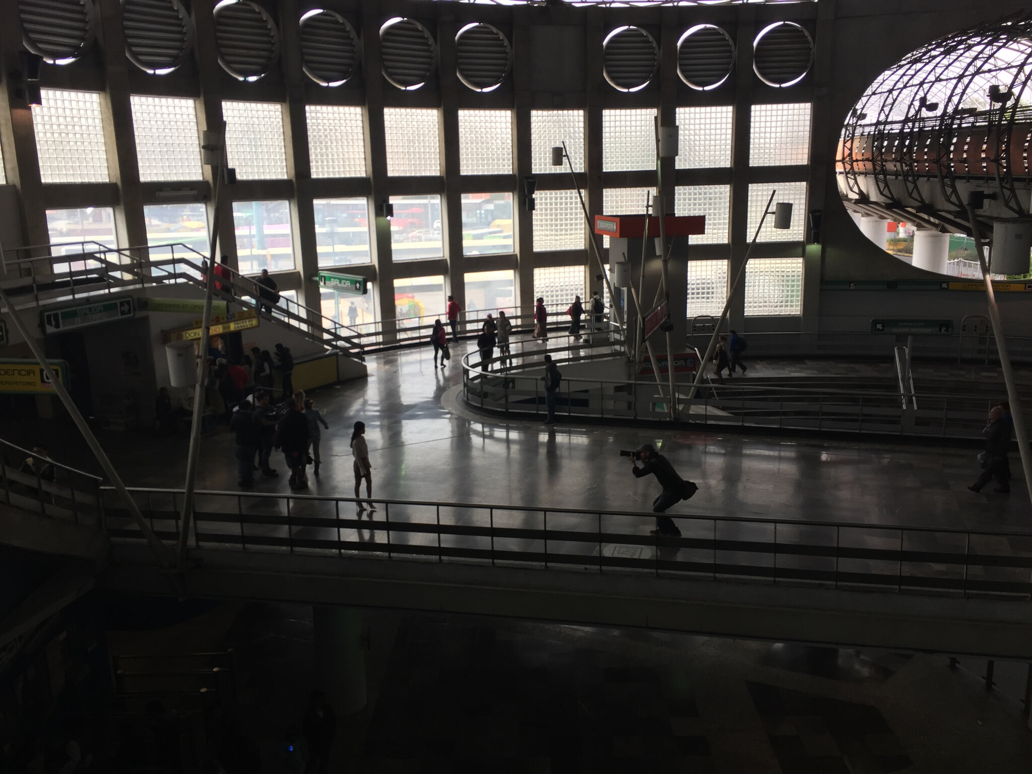 Mexico City. In the distance, a stills photographers captures his subject at the train station.