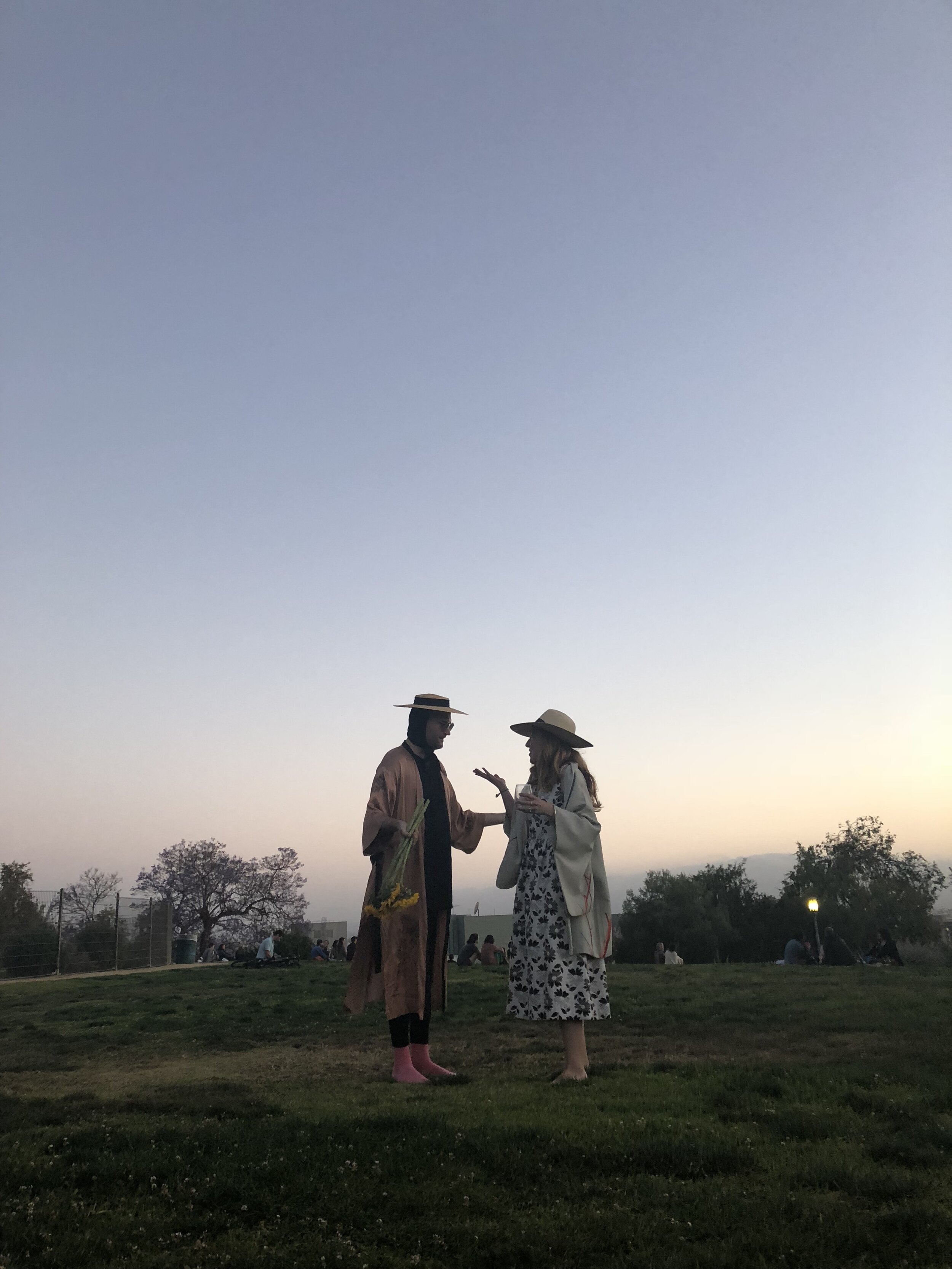 Los Angeles, CA. Two friends celebrate a reunion on a special birthday picnic.