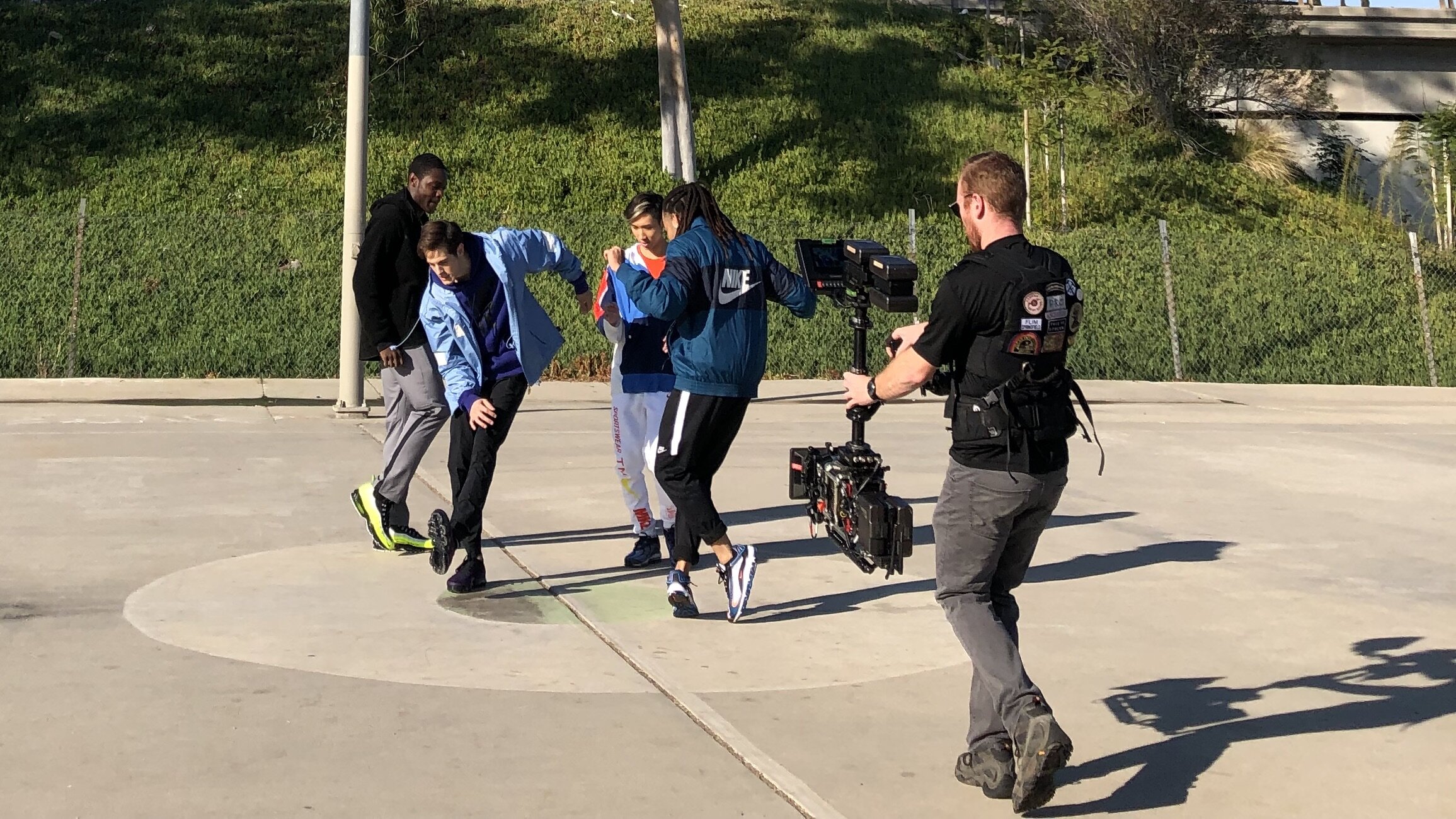 Los Angeles, CA. A steadicam op circles talent as they dance for a Nike spot.