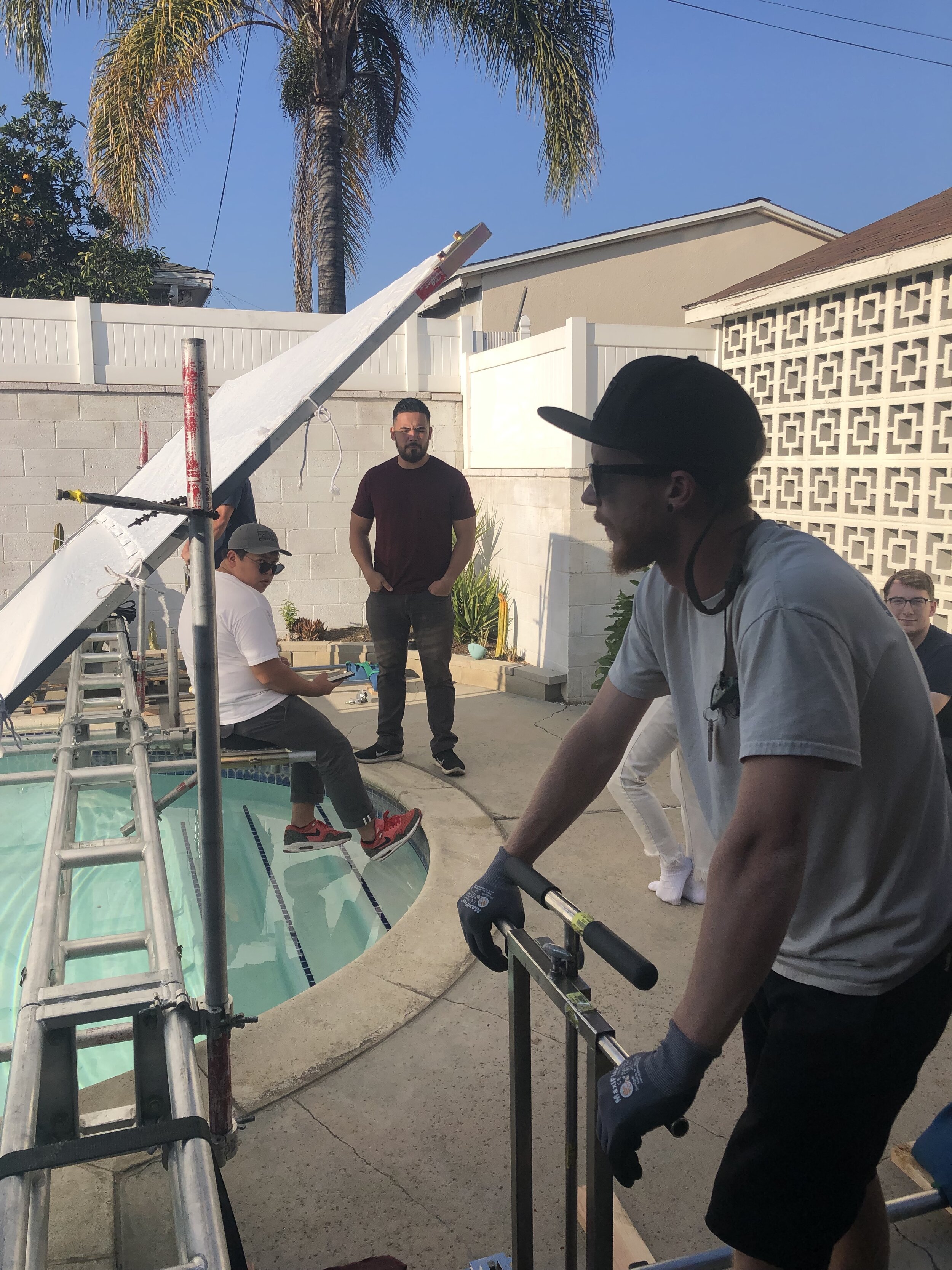 Los Angeles, CA. Key Grip and Cinematographer discuss strategy for a dolly shot.
