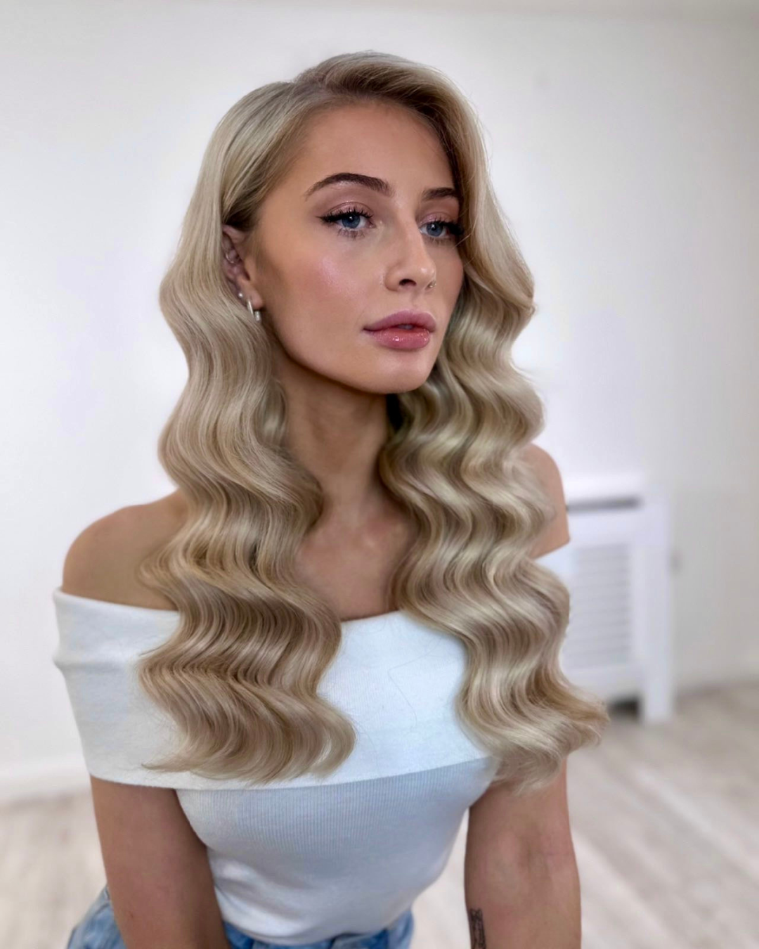 Bridal hair trial session wearing white top and glam waveswith hairstylist in Galway for a destination and Irish bride