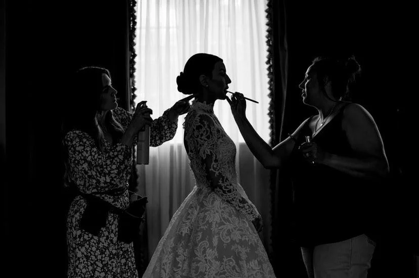Bridal hairstylist styling a bride’s wedding hair final touches in Markree Castle, Sligo