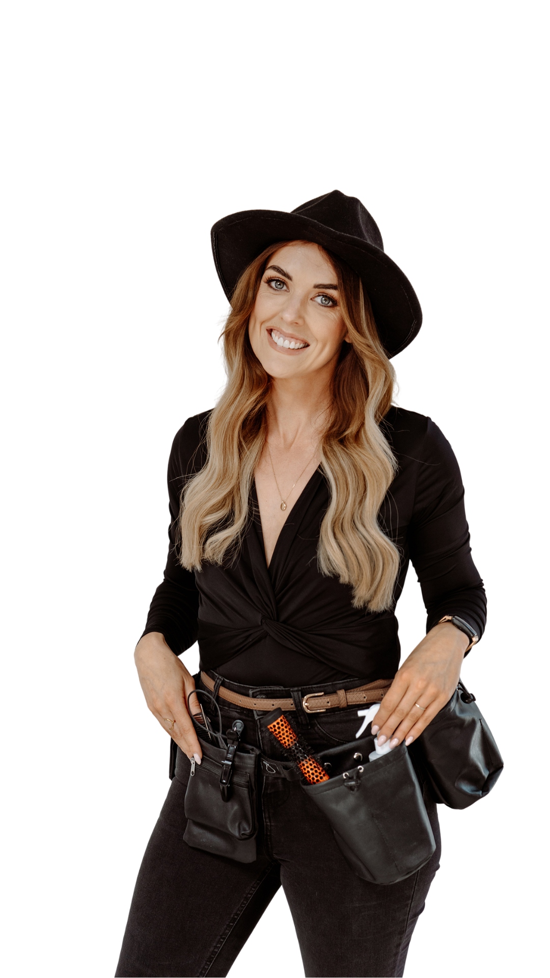 A smiling woman with long wavy blonde hair, wearing a black hat, black top, black jeans, and a waist tool belt that holds various tools.