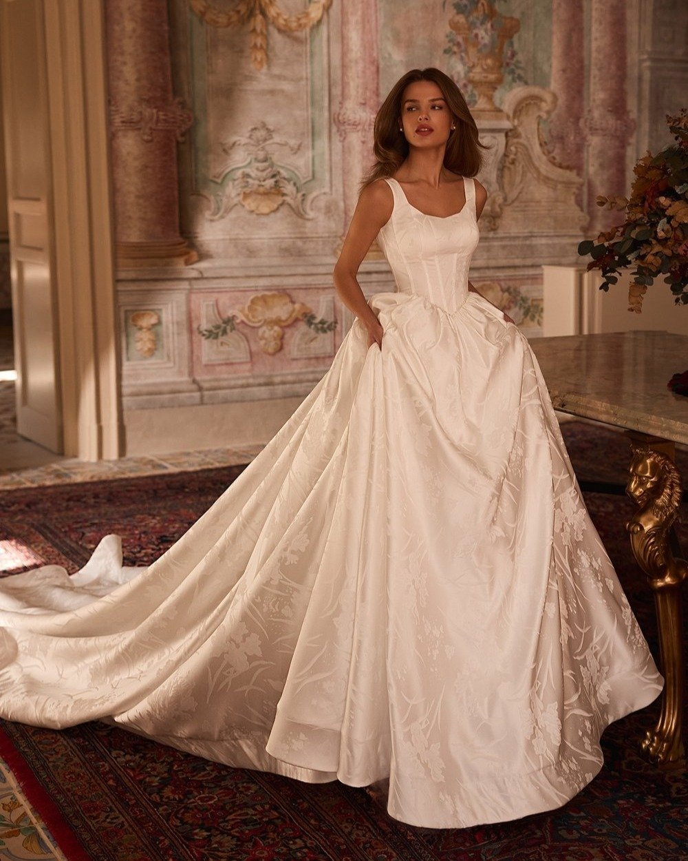 Timeless elegance meets modern function ✨ This regal jacquard ball gown stuns with a structured corset bodice, vintage-inspired Basque waist, and voluminous skirt&mdash;complete with hidden pockets (yes, really!). Finished with a dramatic horsehair h