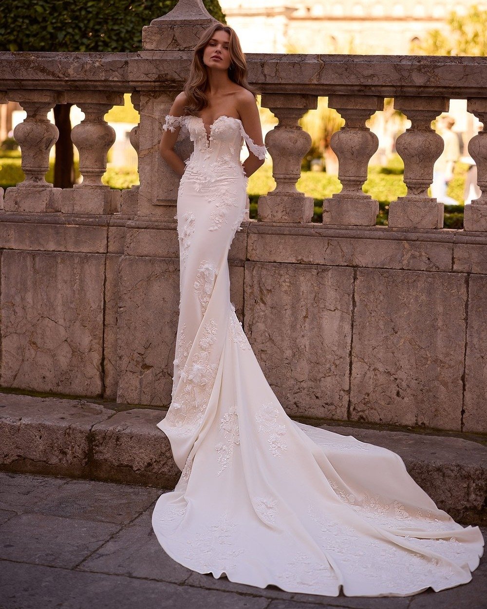 Where romance meets modern elegance 🤍

The Toria gown is a breathtaking off-the-shoulder mermaid silhouette, designed to sculpt and stun. From the structured corset bodice with illusion plunge to the cascading 3D floral lace and flowing crepe chiffo