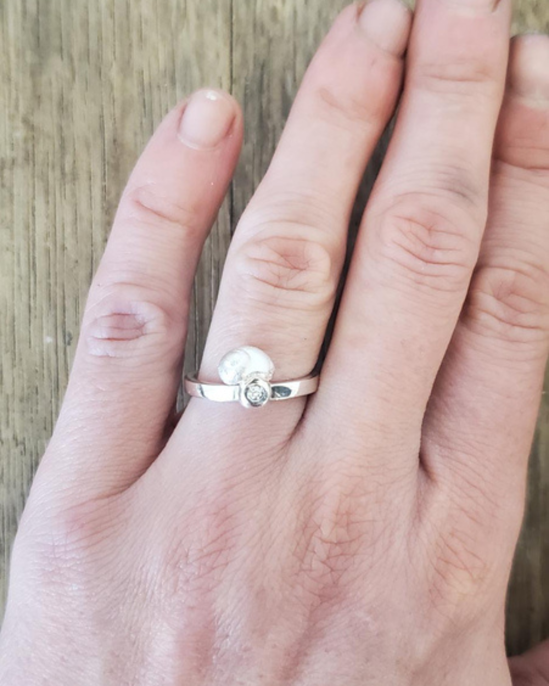 small shell diamond silver ring worn.png