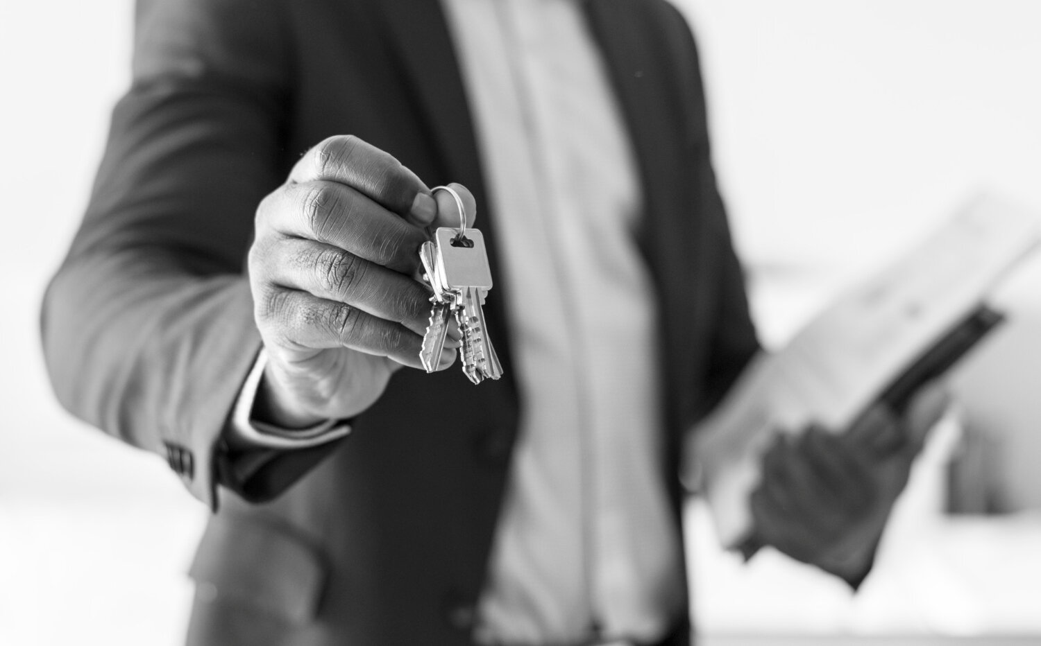 real-estate-agent-handing-house-key.jpg