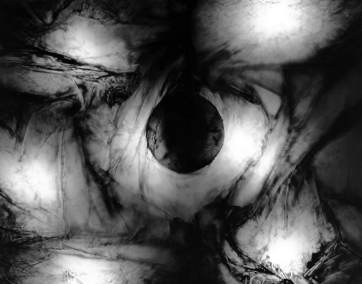 Abstract interpretation of a Black Hole. 
Black Hole #1 - Cliche Verre and Collage - multiple hand altered acrylic, acetate and film sheets directly exposed to a 4x5" sheet of B&W Fomapan 100 Film.