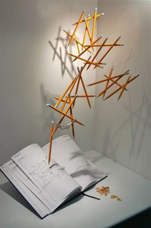 Back-to-school display with suspended pencils arranged above an open planner