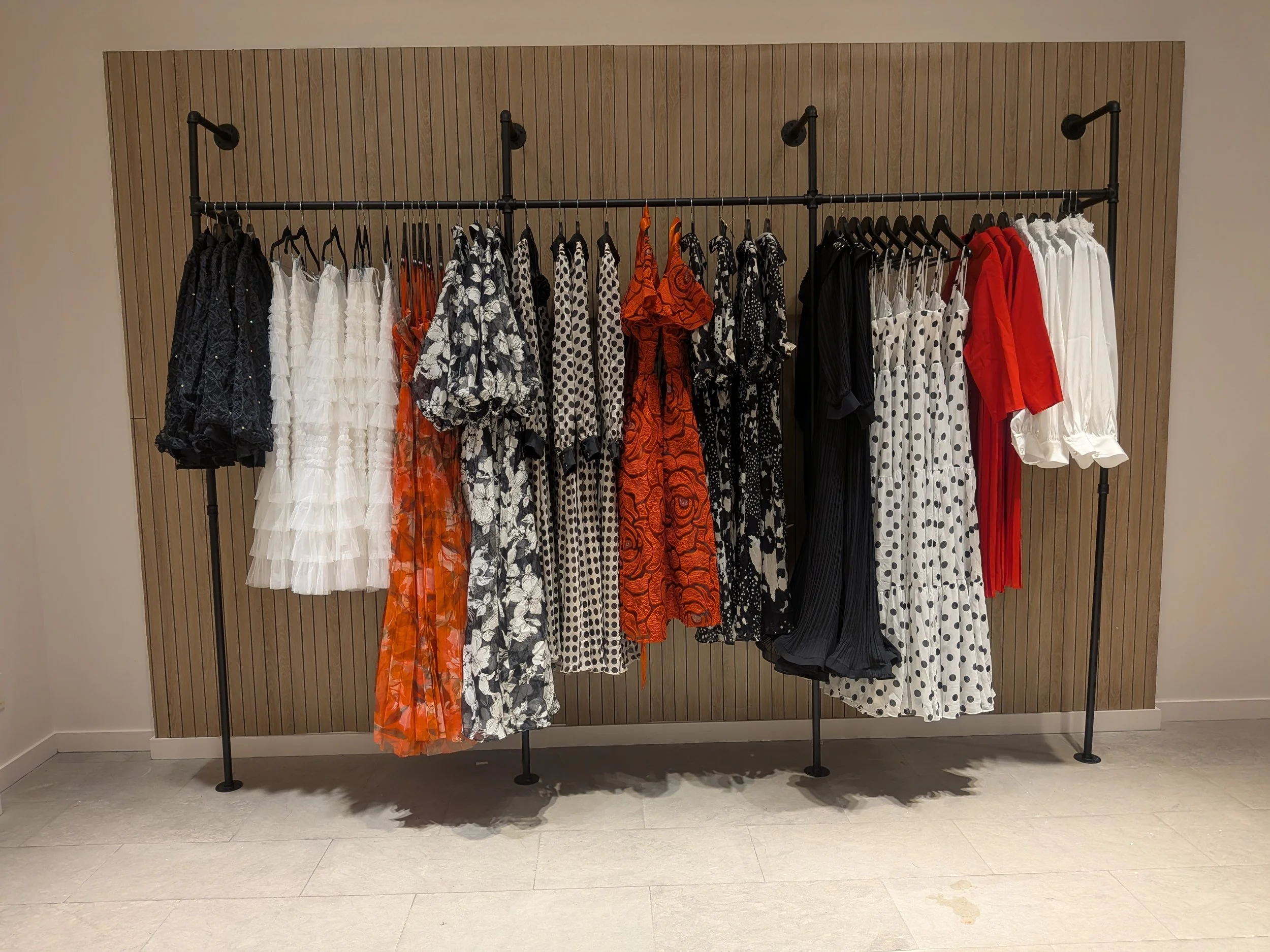 Seasonal fashion collection display at Aimee Boutique featuring organized garment zoning and visual merchandising for enhanced customer navigation.