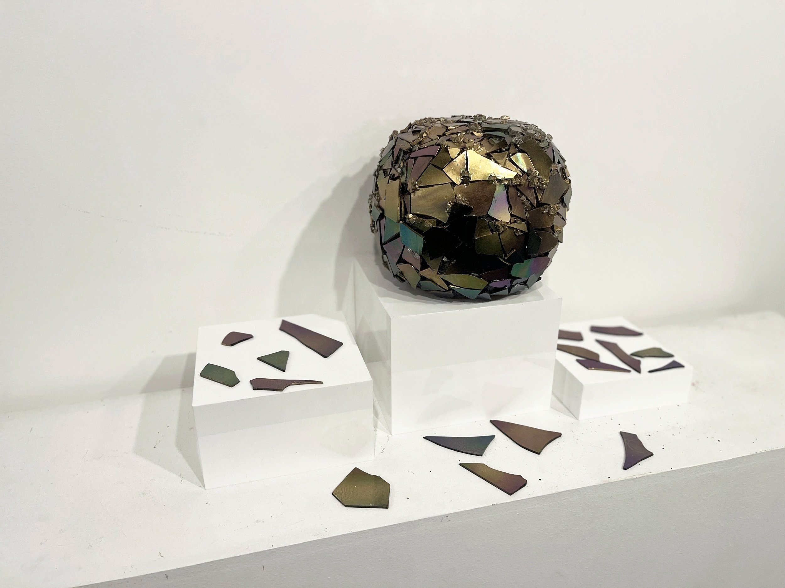 MIRROR IS CRACKING - THE BEGINNING OF BIRTH PAINS
Iridescent glass, plastic, glass shards & spray paint.
2025